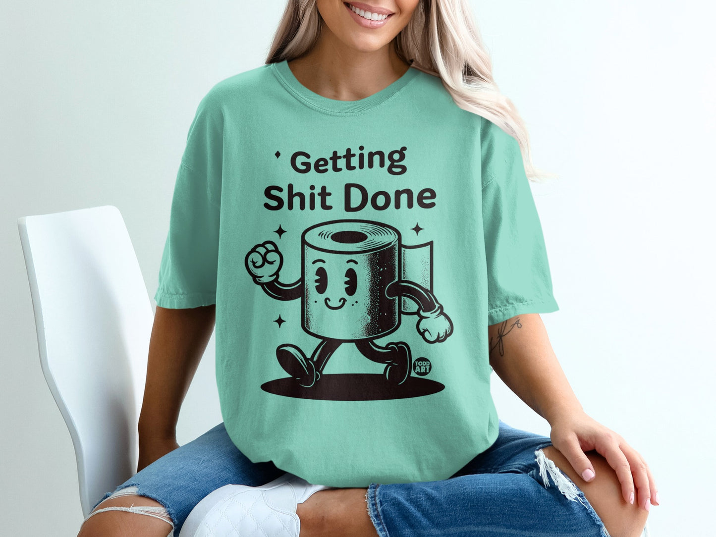 Mint t-shirt with cartoon toilet paper character saying "Getting Shit Done".