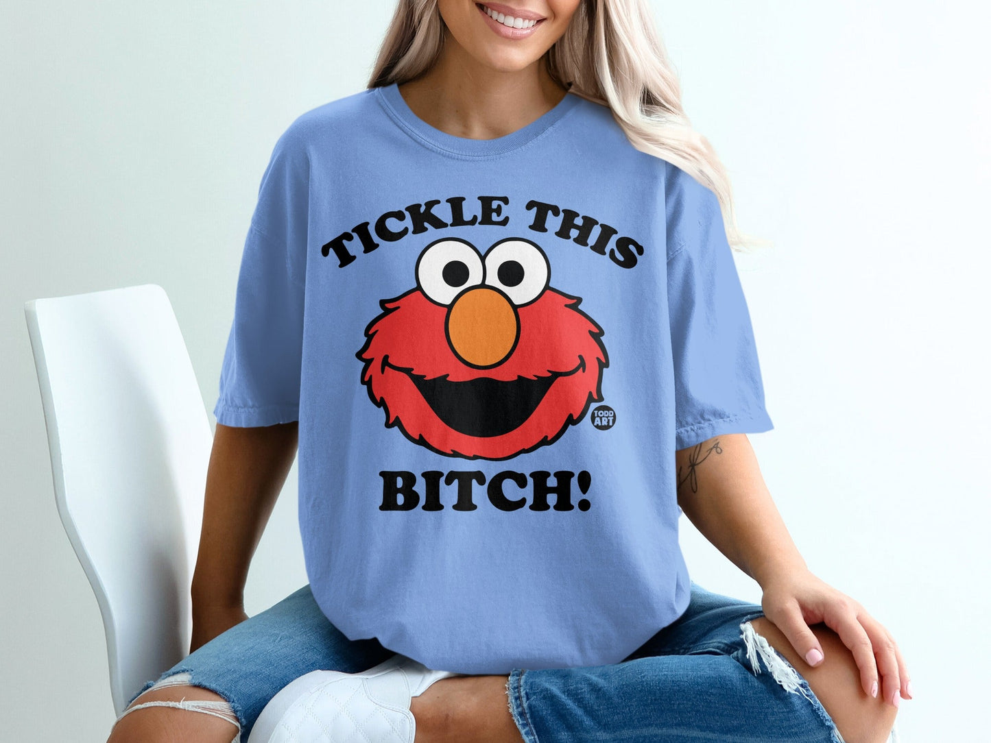 Light blue t-shirt with Elmo graphic and "Tickle This Bitch!" text.