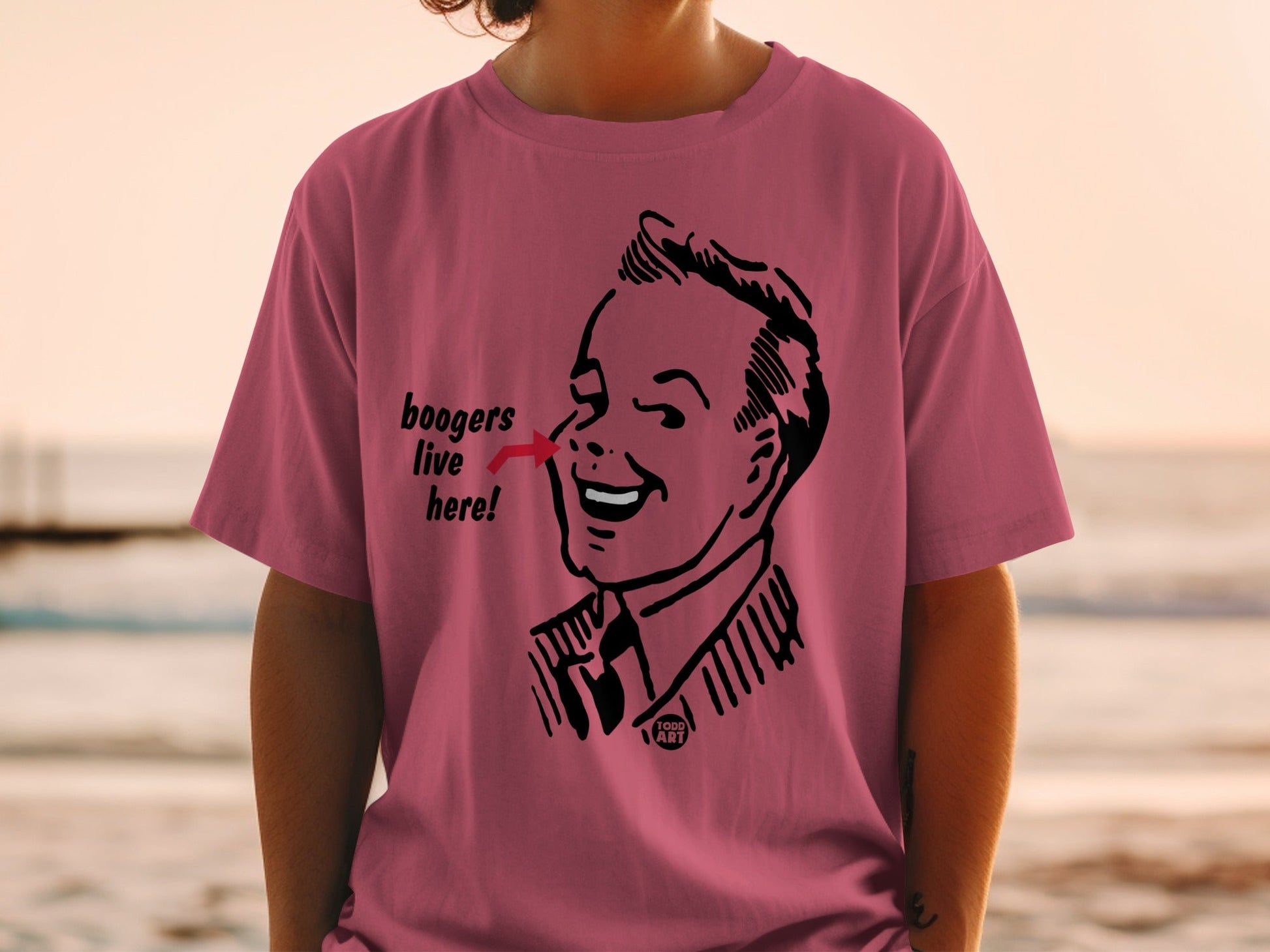 Pink t-shirt with cartoon man's face and "boogers live here!" text.