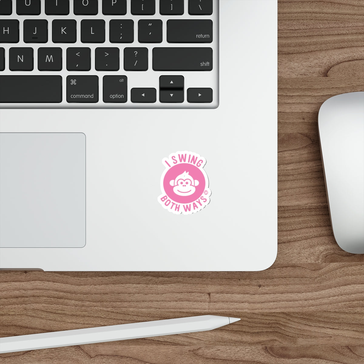 Pink circular sticker with a monkey face and "I swing both ways" text.