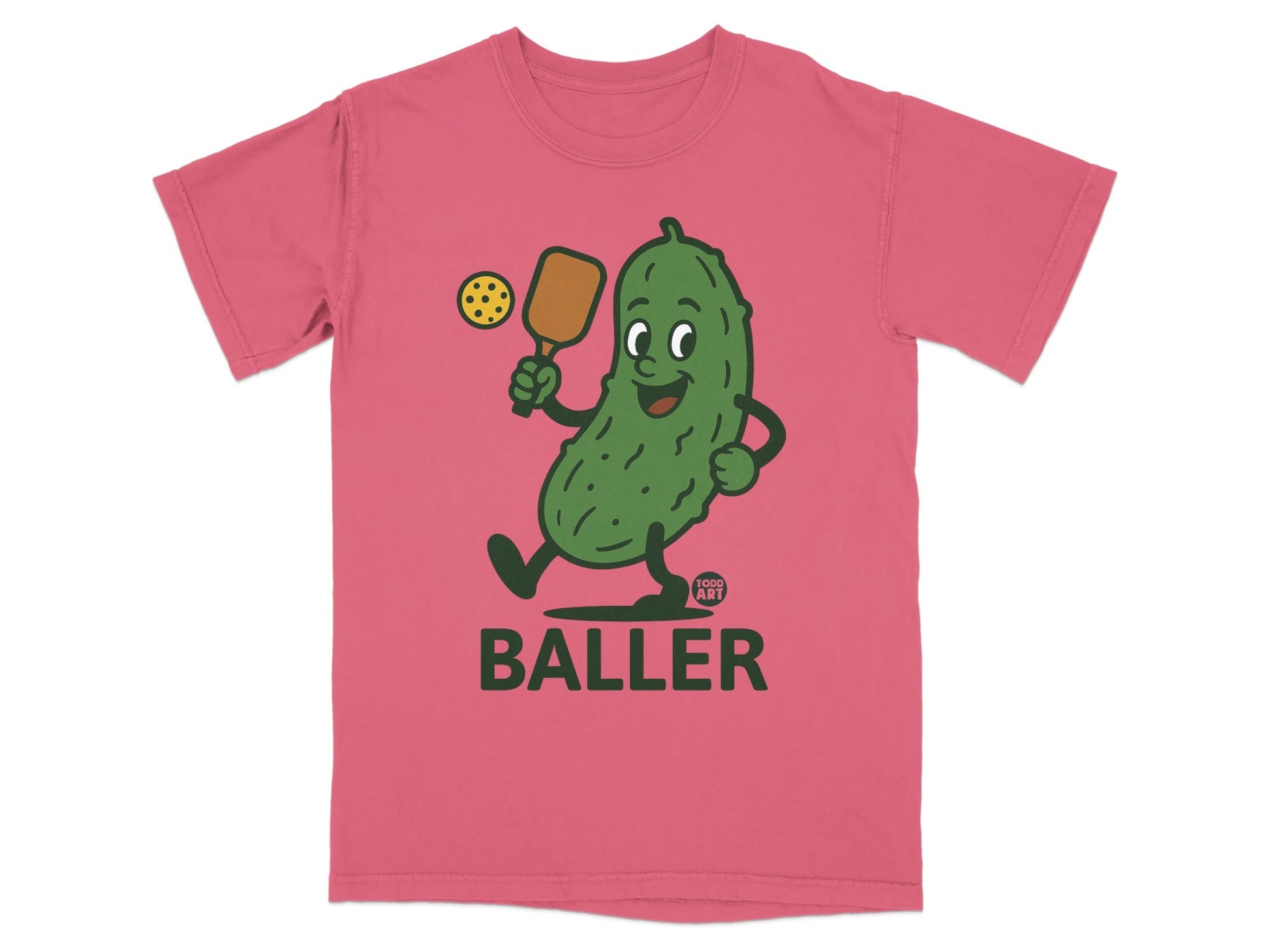 Pink t-shirt with cartoon pickle playing pickleball and the word "BALLER".