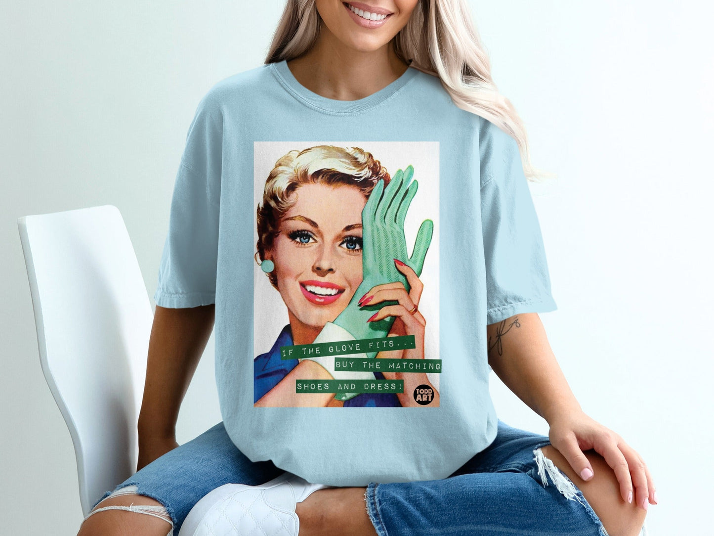 Light blue t-shirt with a vintage woman holding a green glove and text.