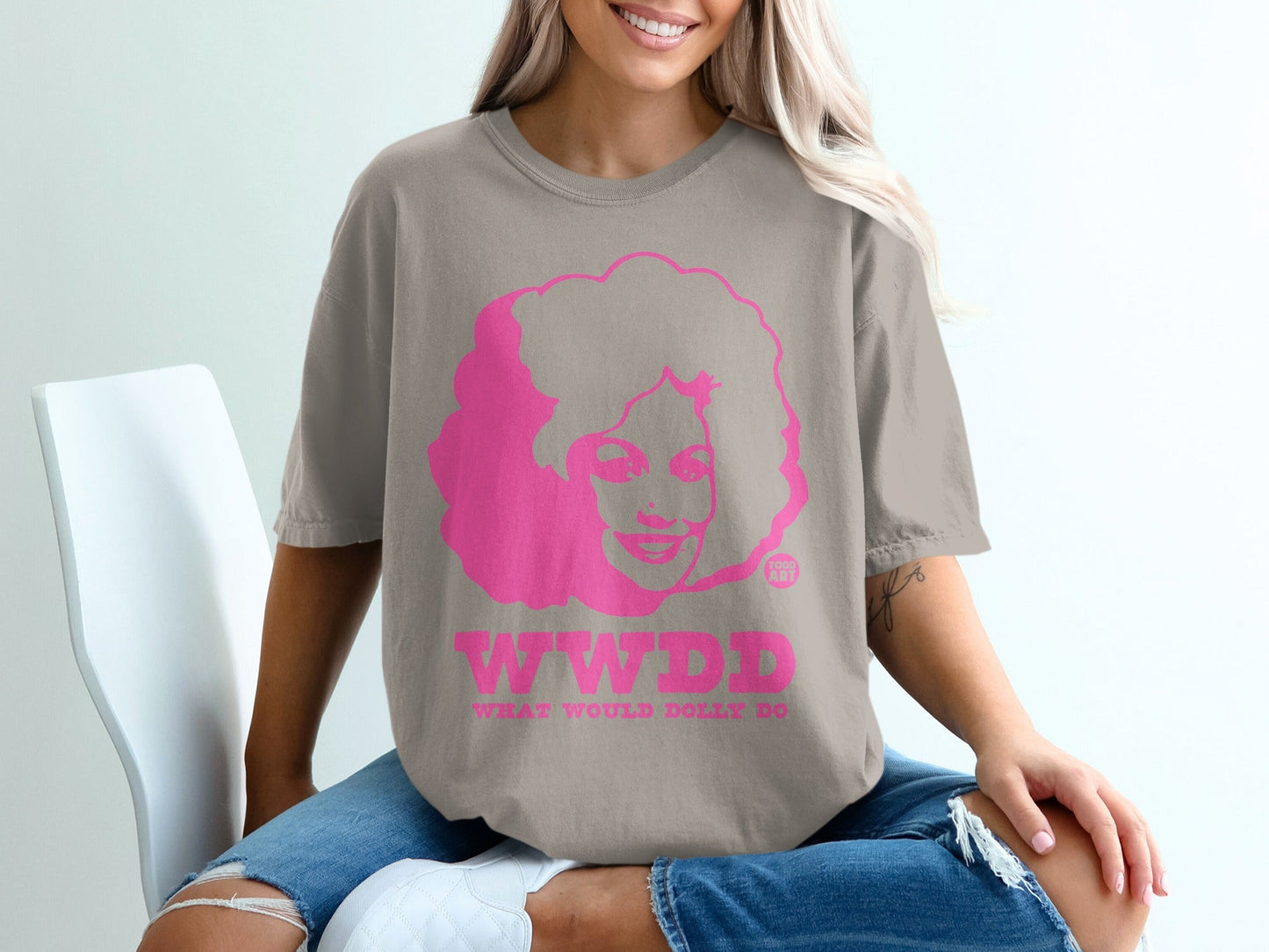 Brown t-shirt with pink graphic of woman and "WWDD" text.