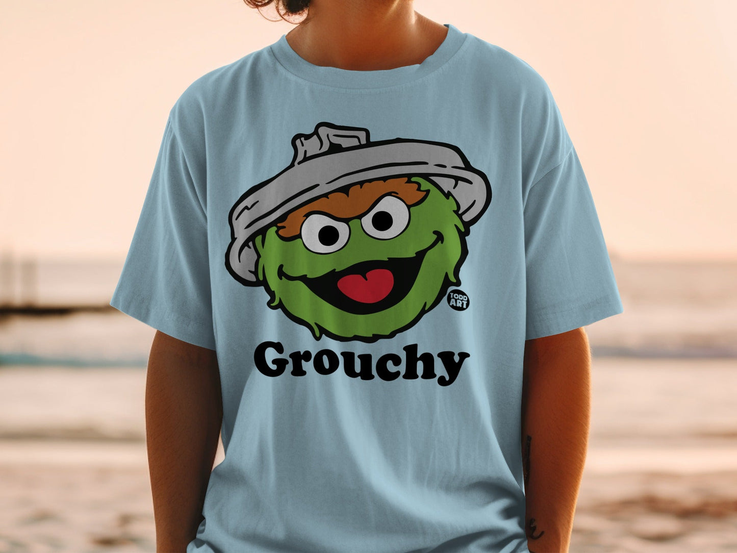 Light blue t-shirt with Oscar the Grouch character and "Grouchy" text.