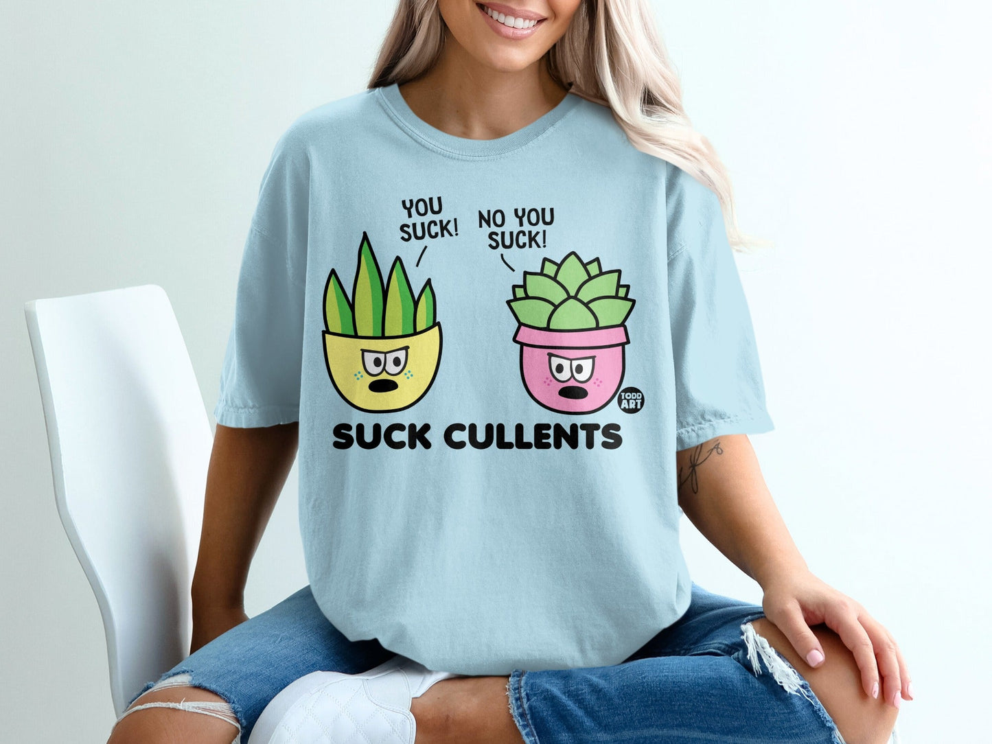 Light blue t-shirt with cartoon succulents saying "YOU SUCK!" and "NO YOU SUCK!".