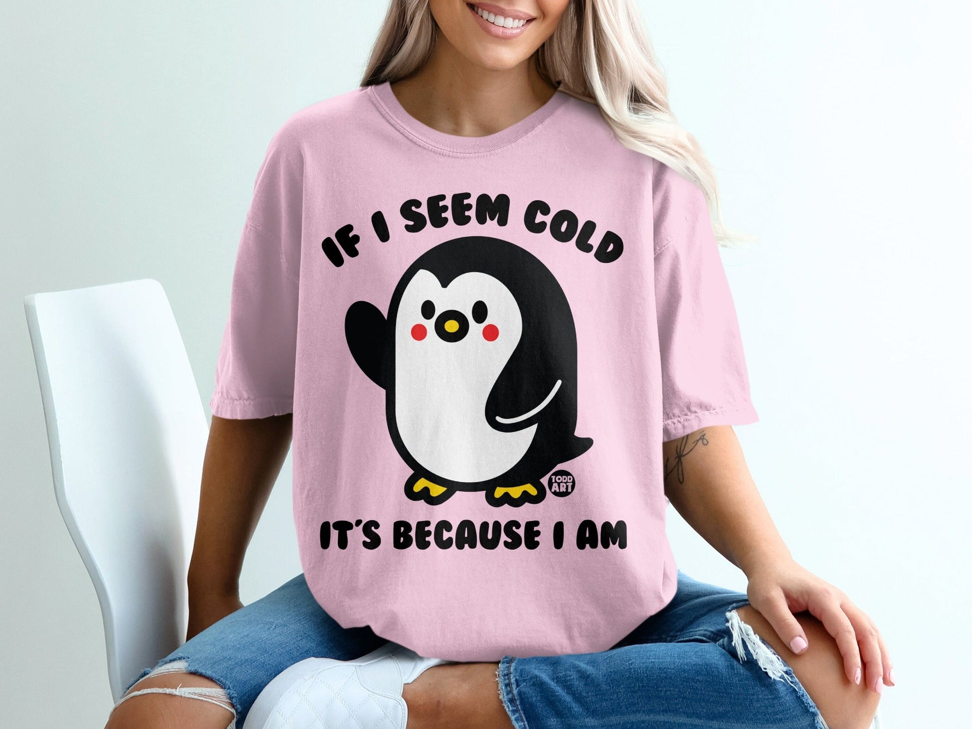 Pink t-shirt with a cartoon penguin and text "IF I SEEM COLD IT'S BECAUSE I AM".
