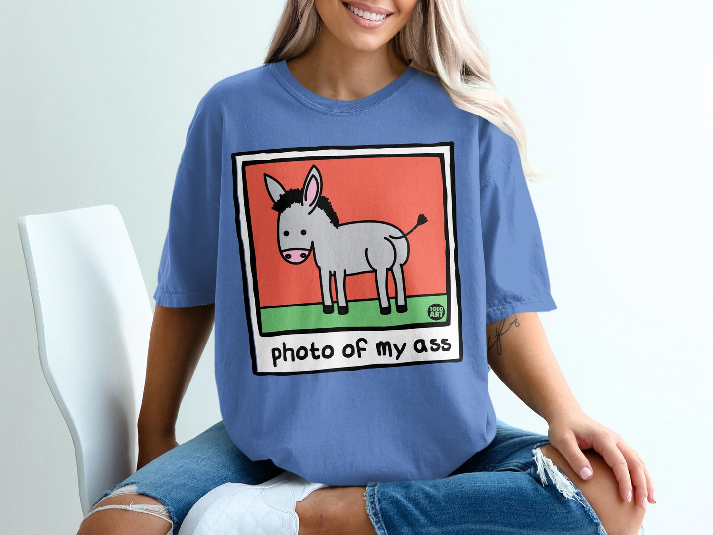 Cartoon donkey illustration with text "photo of my ass" on a blue t-shirt.