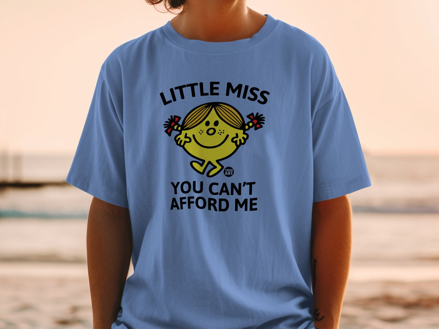 Blue t-shirt with "Little Miss You Can't Afford Me" cartoon graphic.