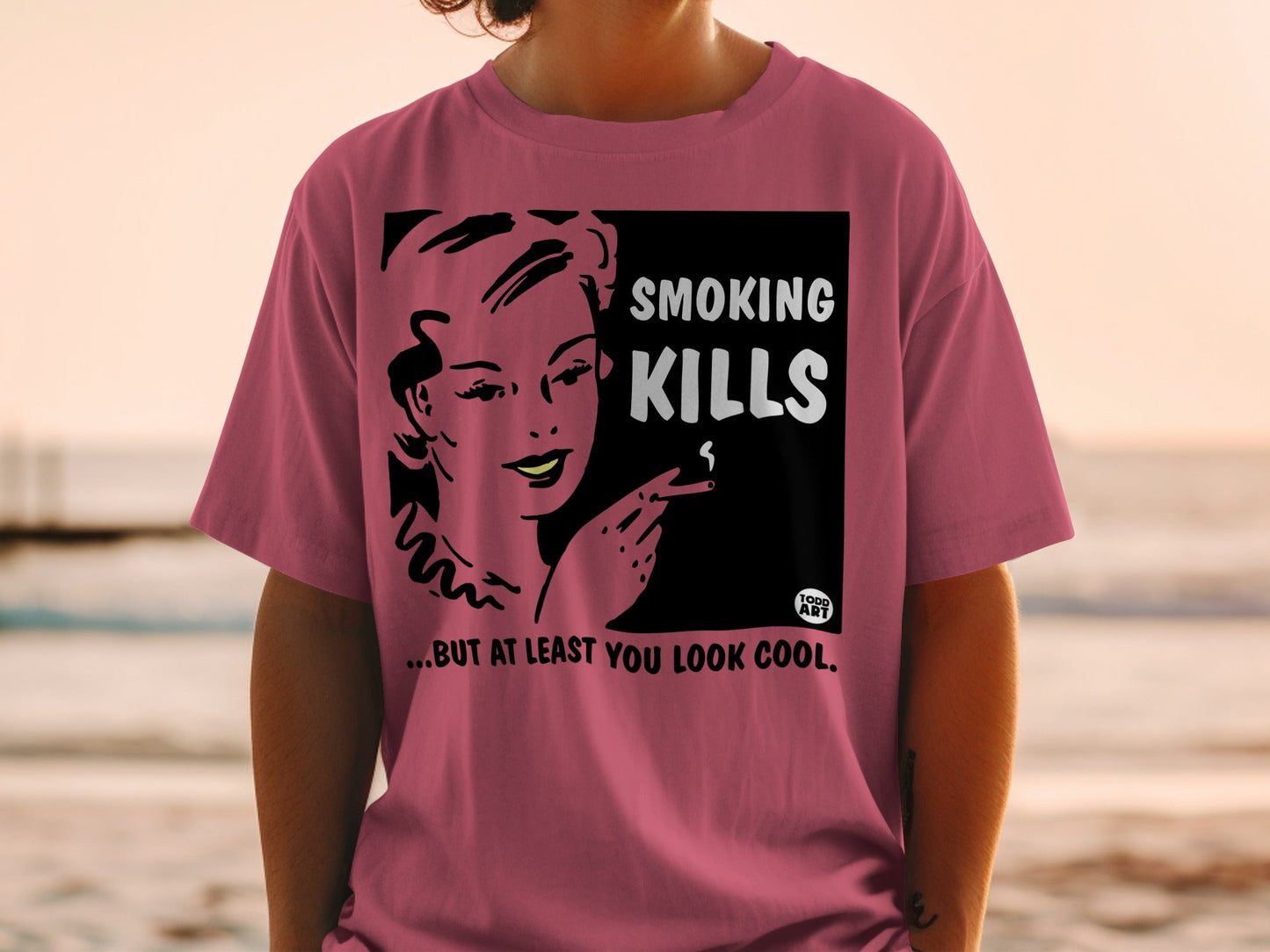 T-shirt with black and white graphic of woman smoking, text reads "SMOKING KILLS...BUT AT LEAST YOU LOOK COOL."