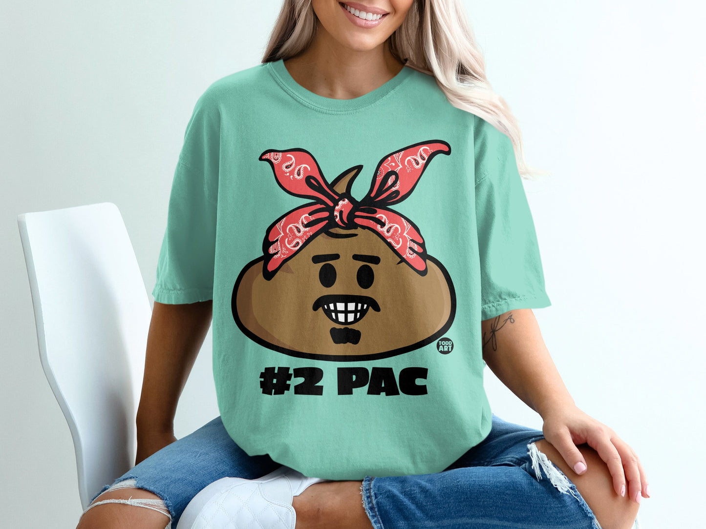 Teal t-shirt with cartoon face wearing red bandana, "#2 PAC" text.