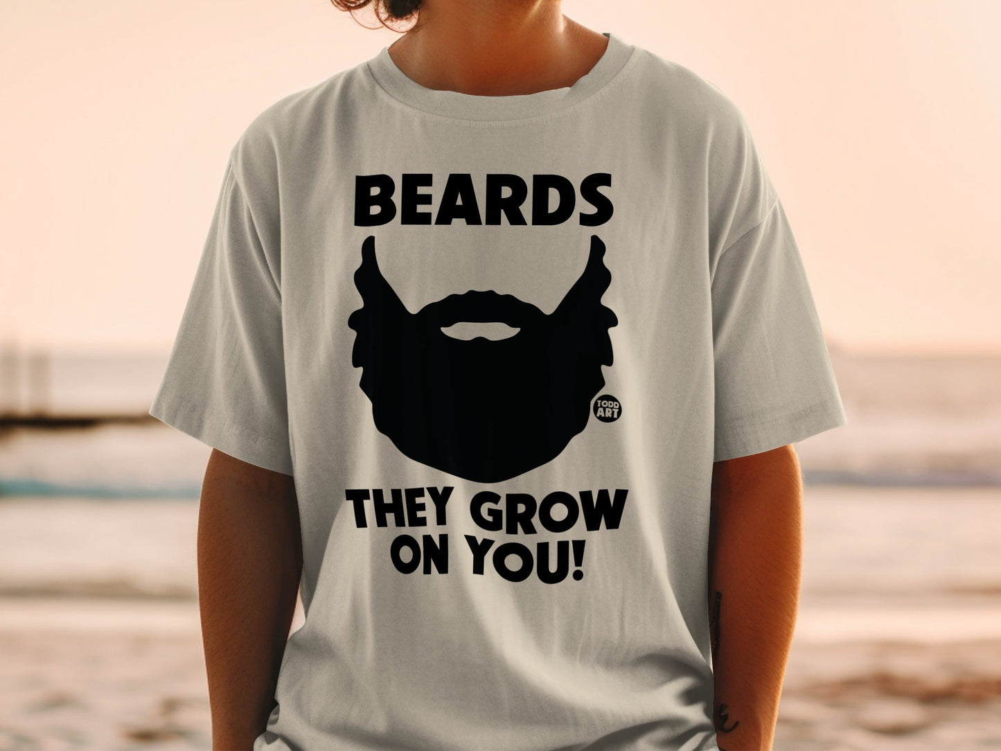 T-shirt with black beard graphic and text "BEARDS THEY GROW ON YOU!".