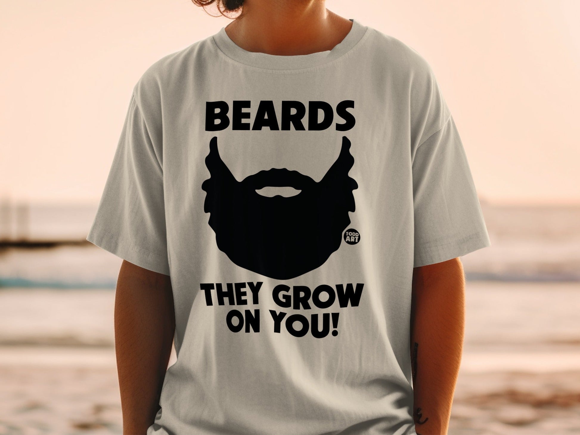 T-shirt with black beard graphic and text "BEARDS THEY GROW ON YOU!".