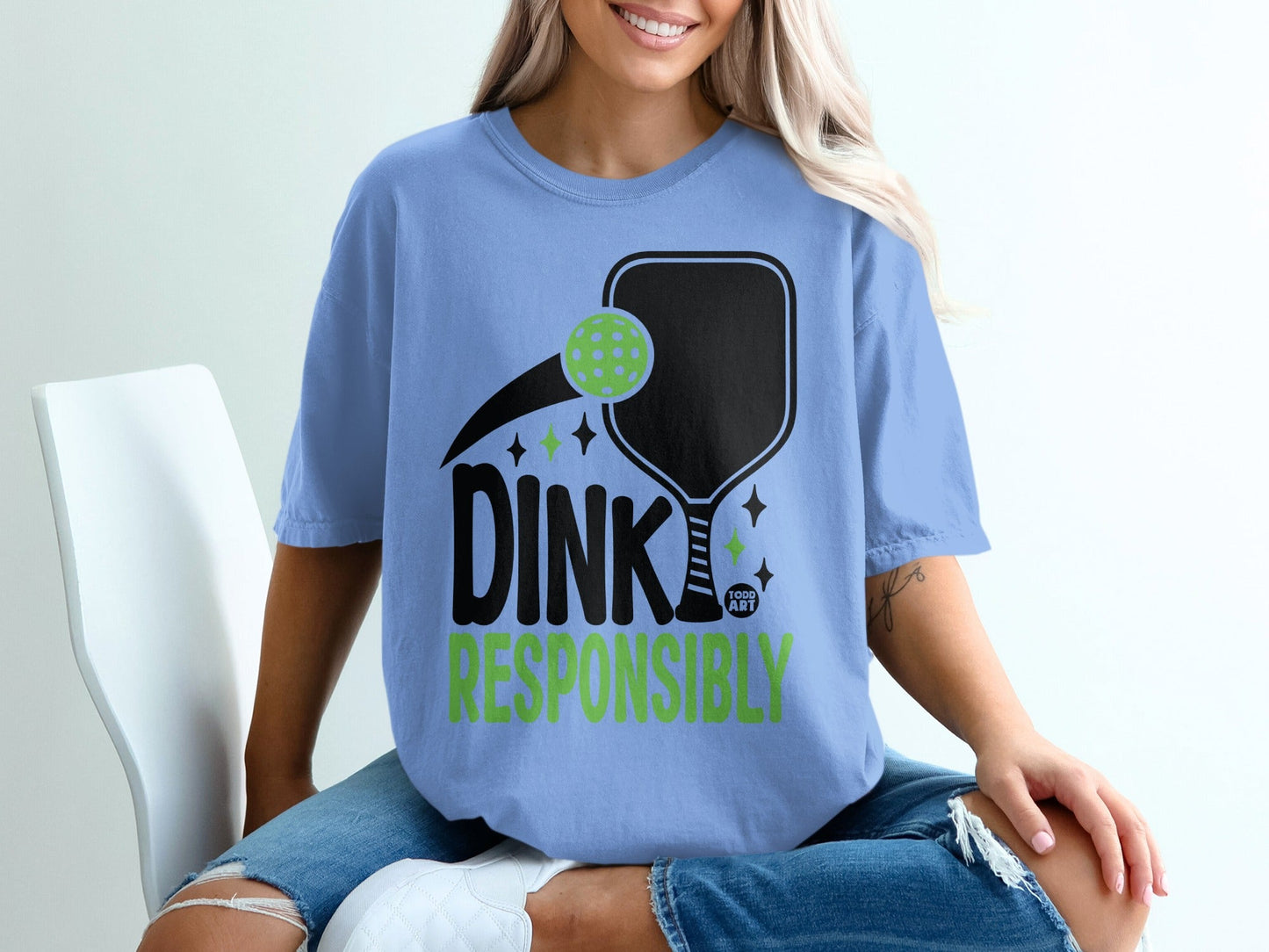 Light blue t-shirt with "DINK RESPONSIBLY" and pickleball paddle graphic.