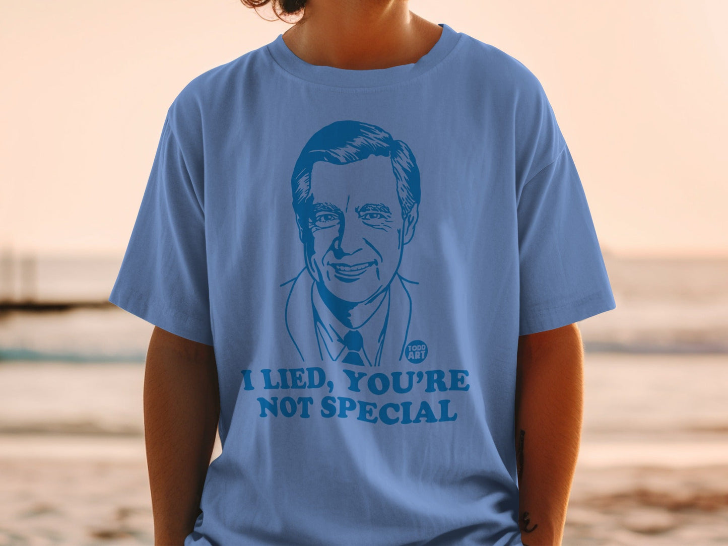 Blue t-shirt with a portrait of Mister Rogers and the text "I Lied, You're Not Special."