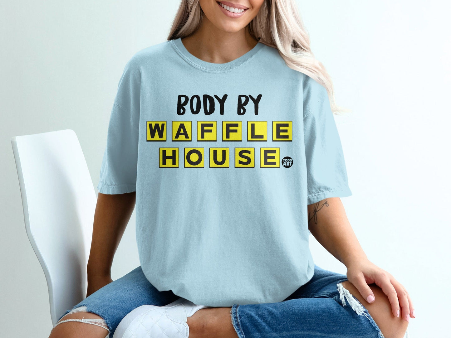 Light blue t-shirt with yellow "BODY BY WAFFLE HOUSE" text.