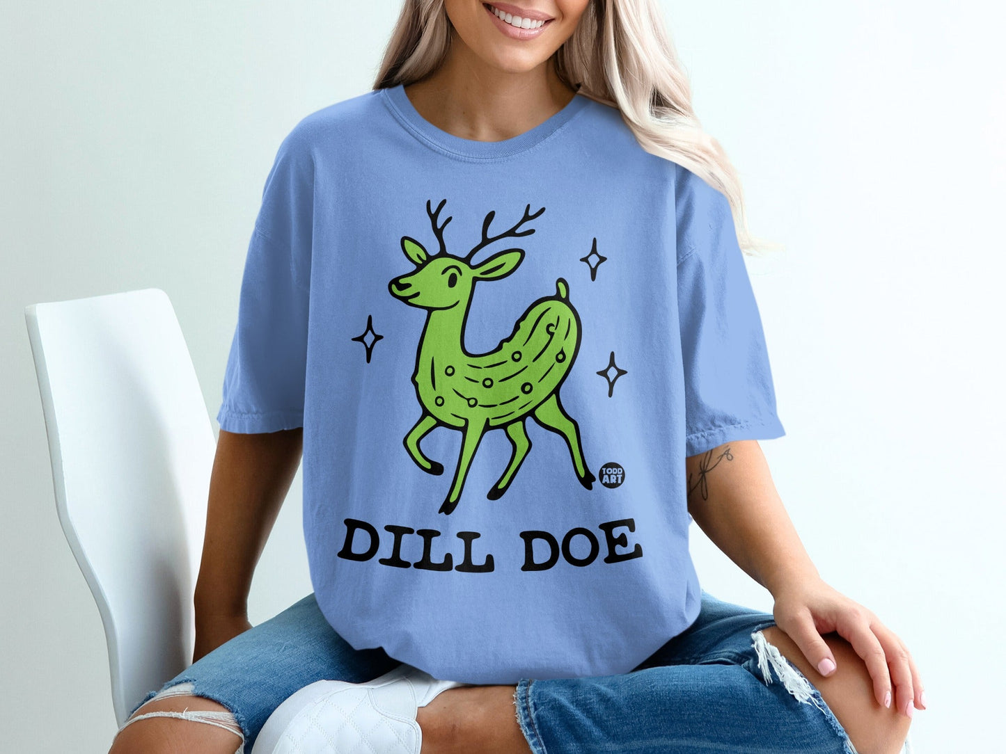 Green deer with pickle body and "Dill Doe" text on a blue t-shirt.