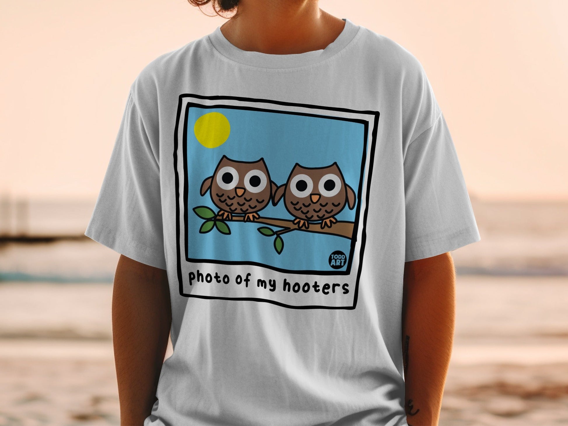 Two cartoon owls on a branch with "photo of my hooters" text.