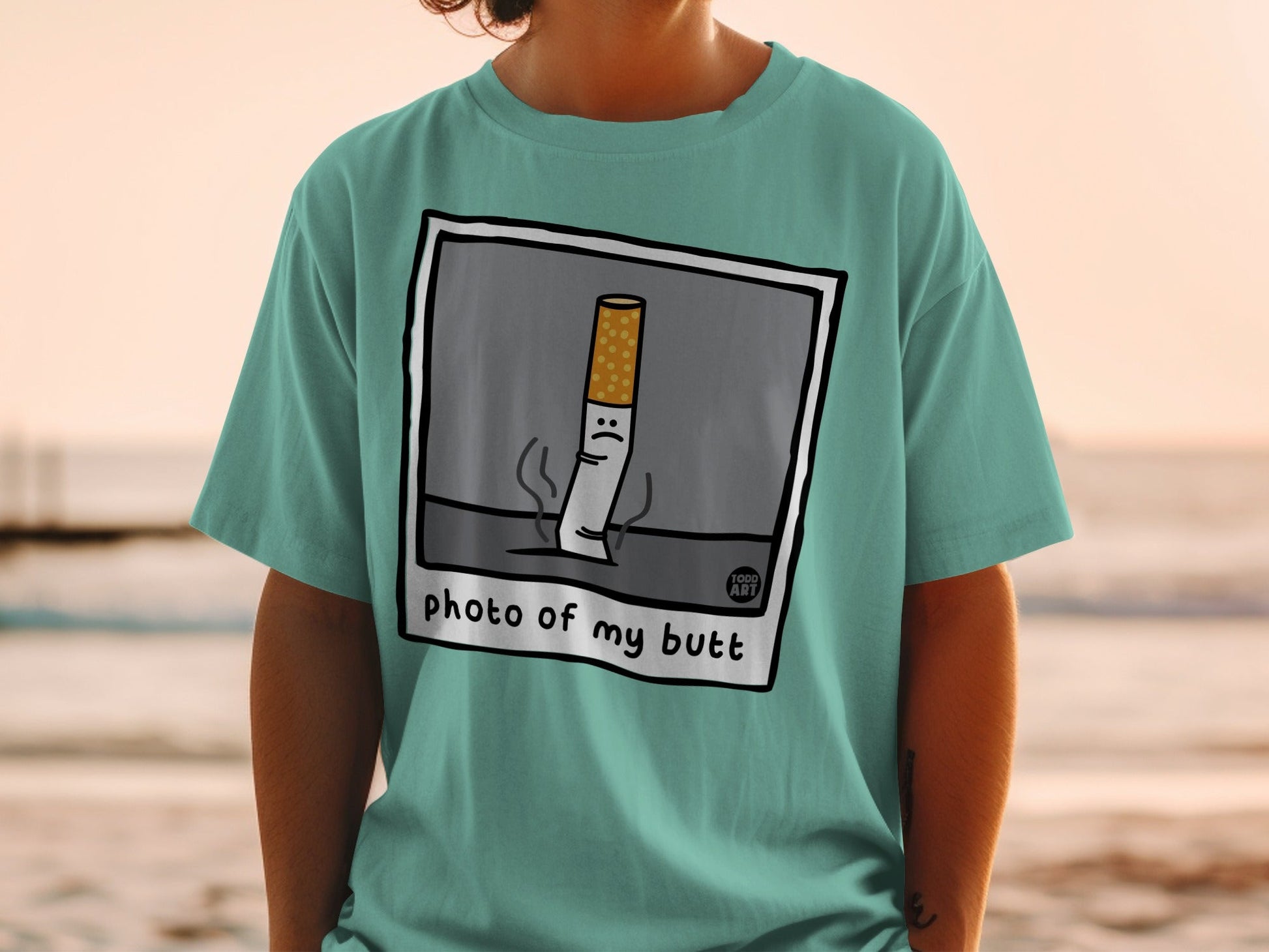 T-shirt with cartoon cigarette illustration that says "photo of my butt."