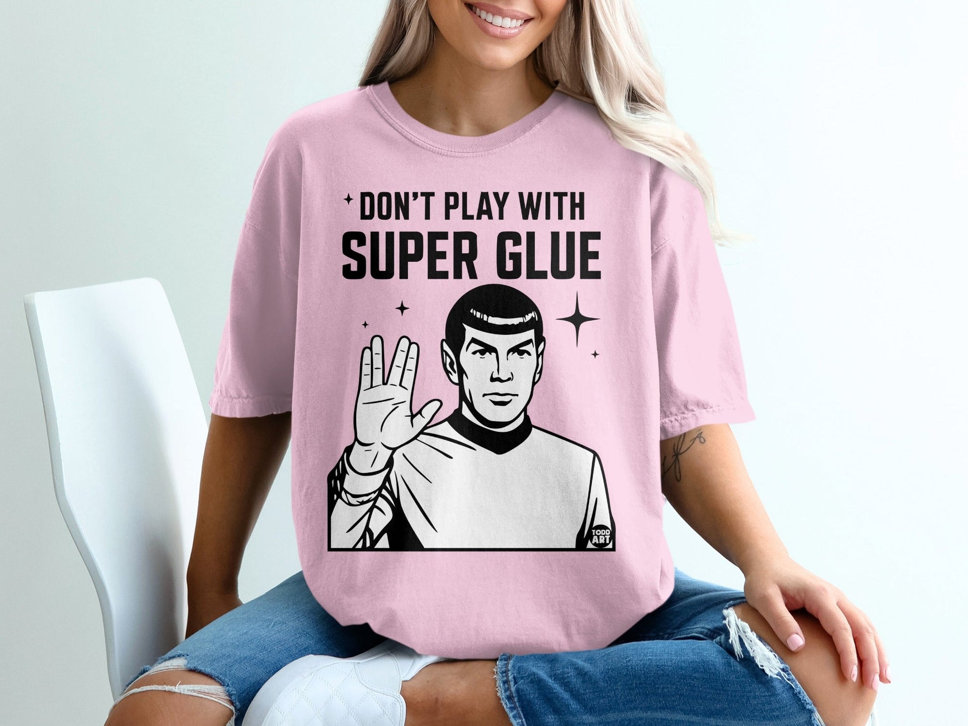 Pink t-shirt with "Don't play with super glue" and Spock graphic.