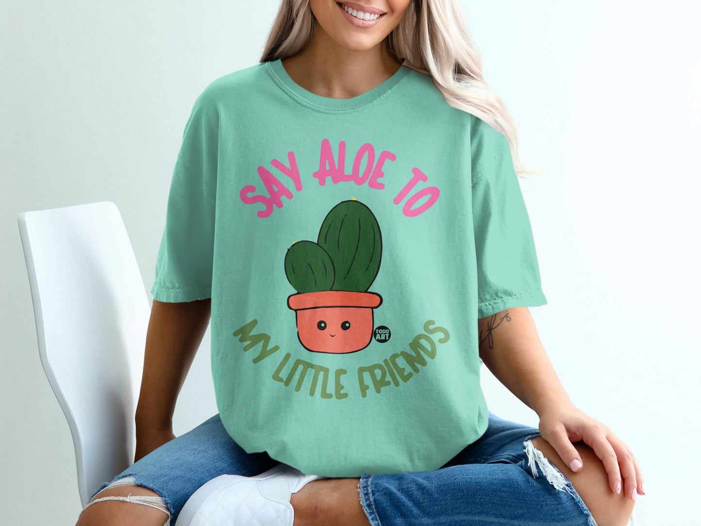Teal t-shirt with "Say Aloe to My Little Friends" and a potted cactus.