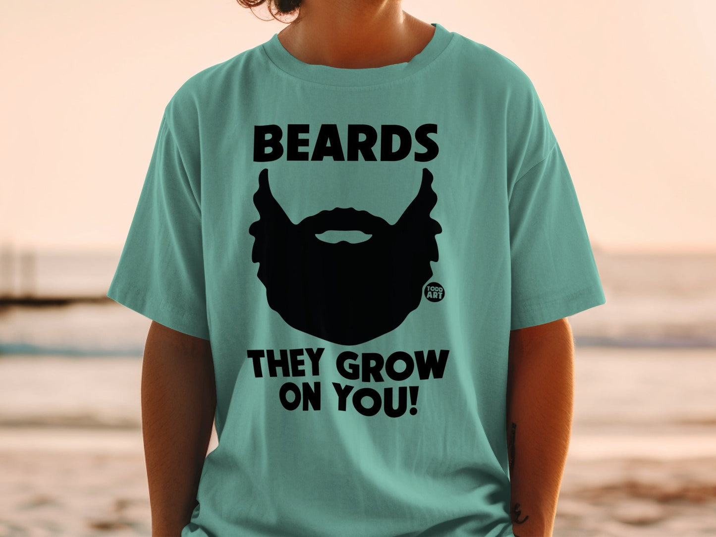 Teal t-shirt with black beard graphic and text "BEARDS THEY GROW ON YOU!".