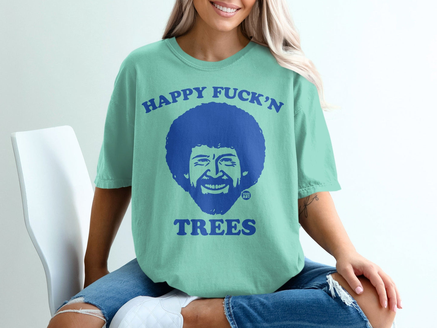 Light blue t-shirt with Bob Ross's face and "Happy Fuck'n Trees" text.