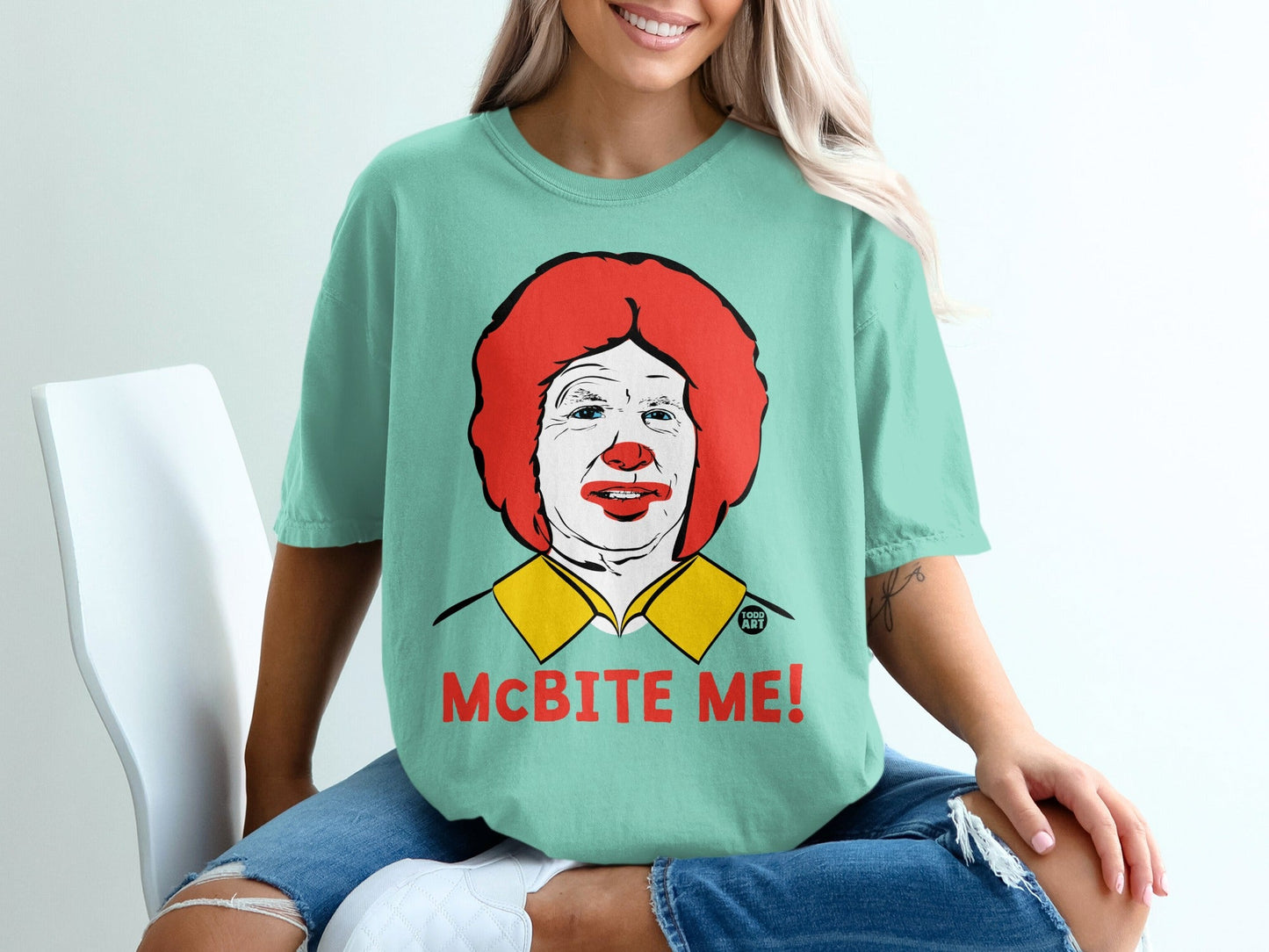 Teal t-shirt with Ronald McDonald graphic and "McBITE ME!" text.