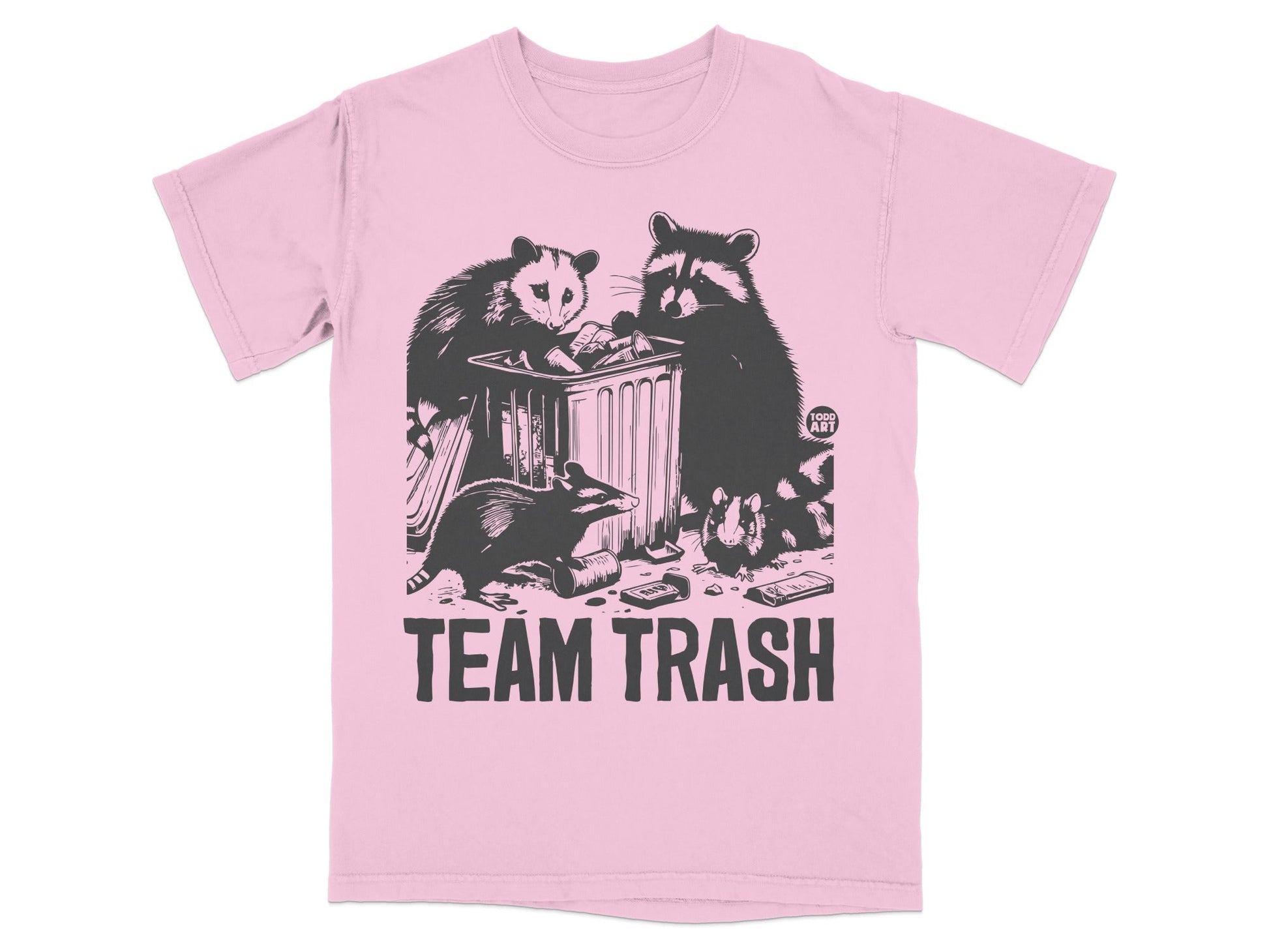 Raccoons and opossum dumpster diving on a pink t-shirt with "TEAM TRASH" text.