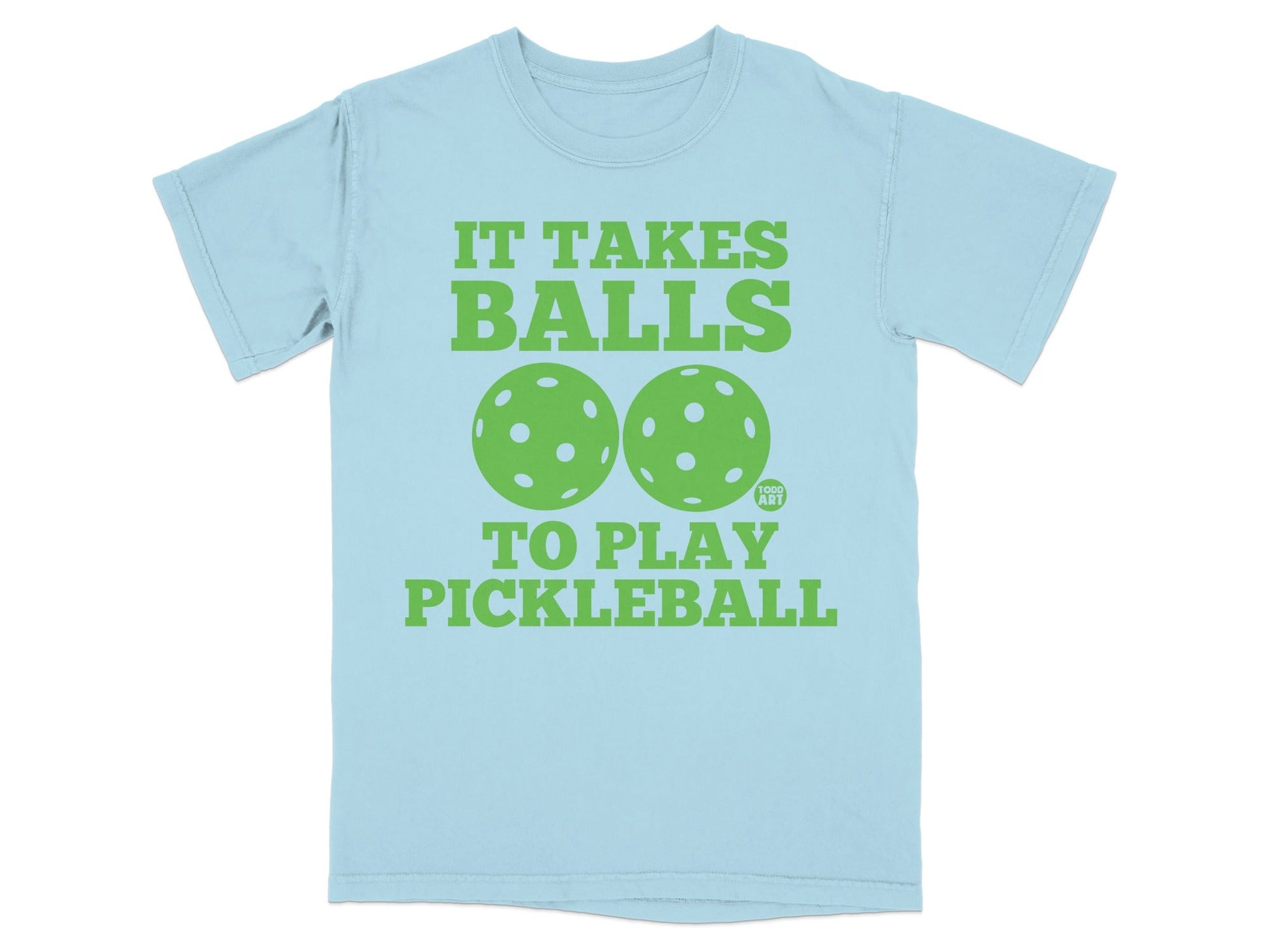 Light blue t-shirt with green text and pickleball graphics reading "It Takes Balls to Play Pickleball".
