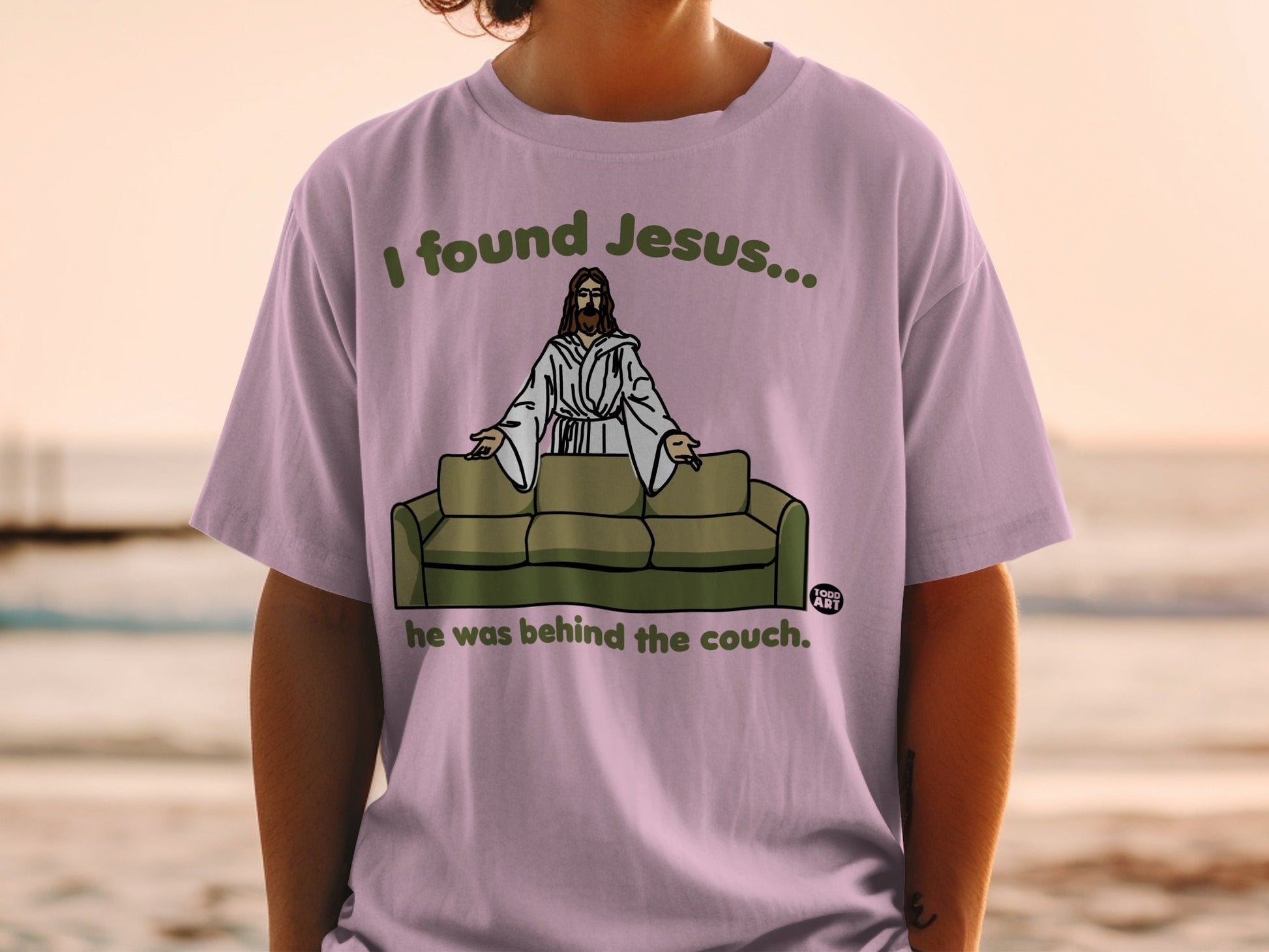 Purple t-shirt with Jesus on a couch graphic and text "I found Jesus..."
