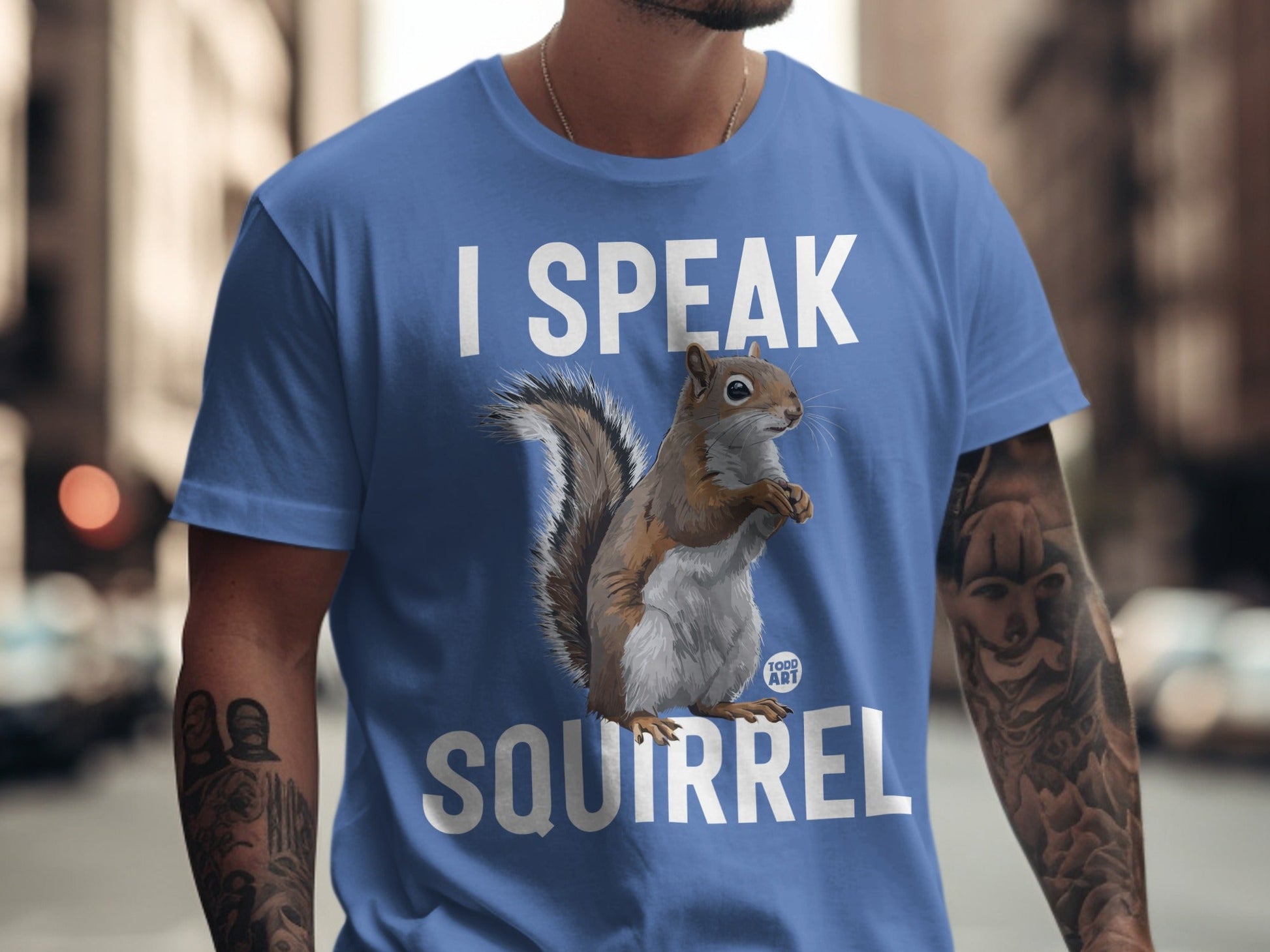 Blue t-shirt with "I SPEAK SQUIRREL" text and squirrel graphic.