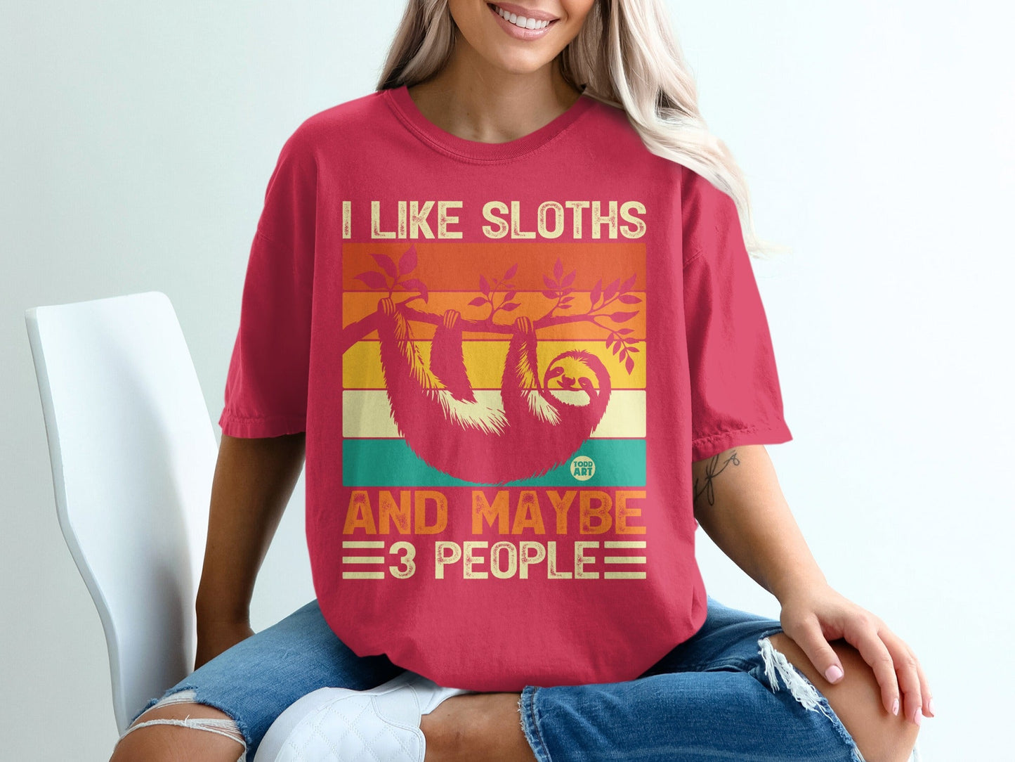 Pink t-shirt with "I like sloths and maybe 3 people" and sloth graphic.