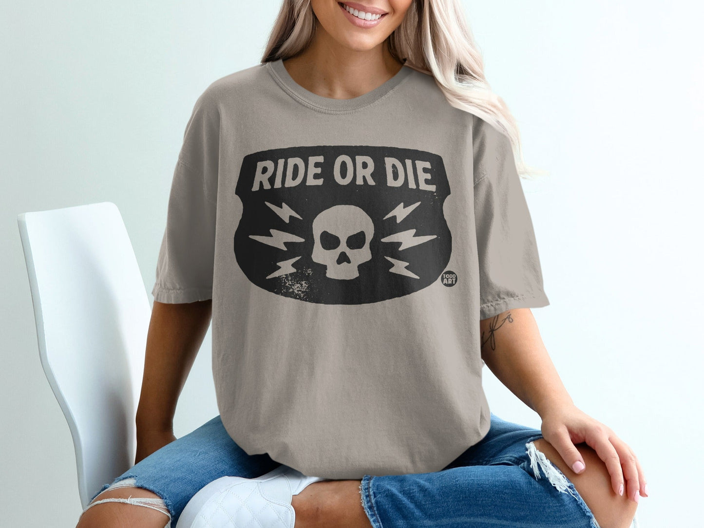 Tan t-shirt with "RIDE OR DIE" text and skull graphic.