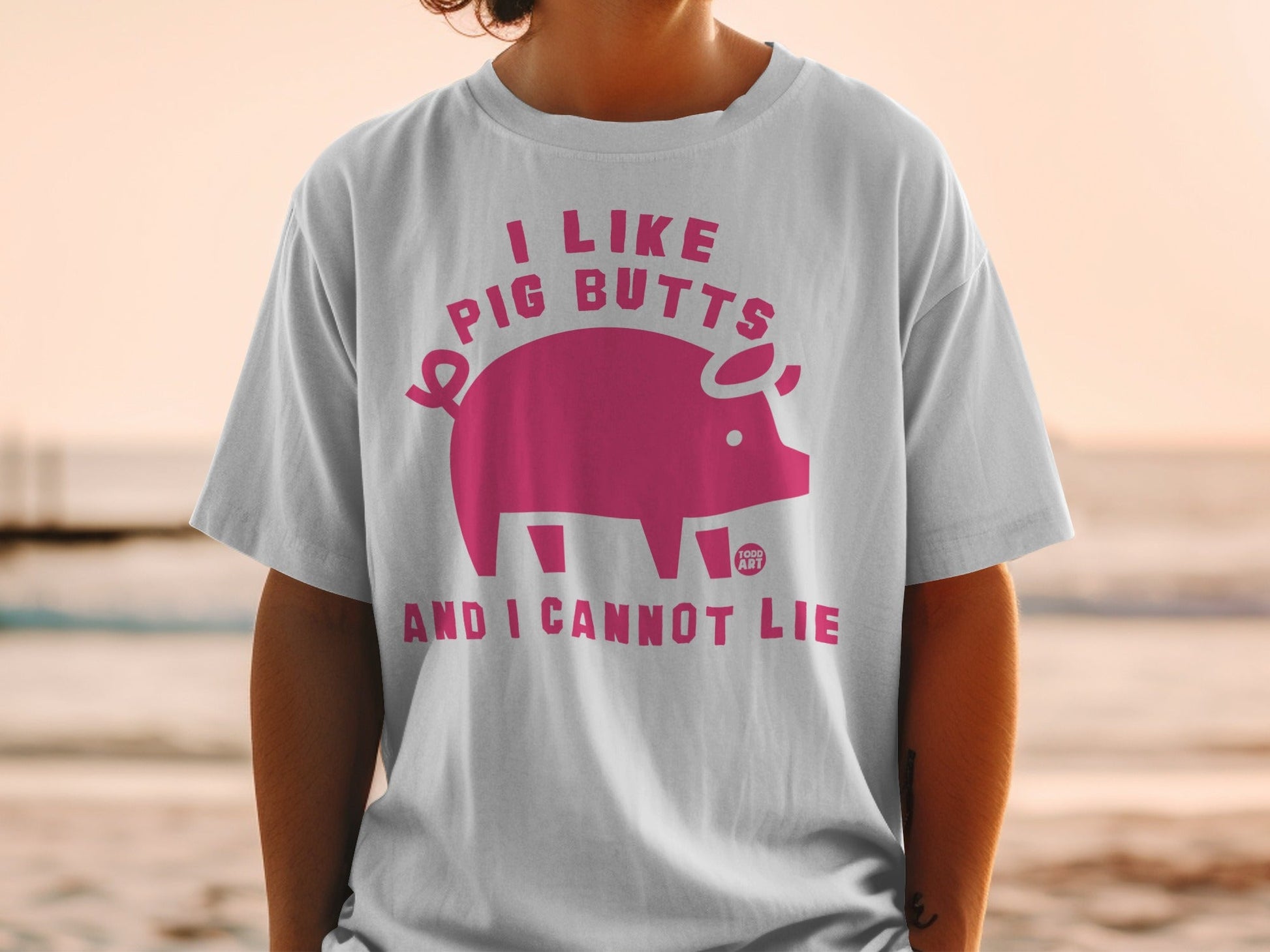 White t-shirt with "I like pig butts and I cannot lie" text and pig graphic.