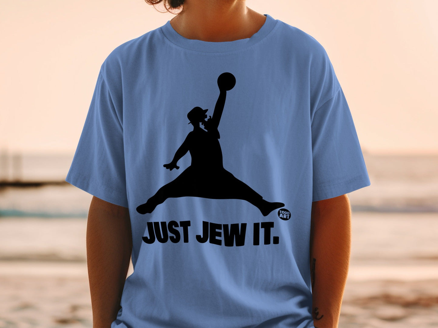 Black silhouette of man dunking a basketball on a light blue t-shirt.