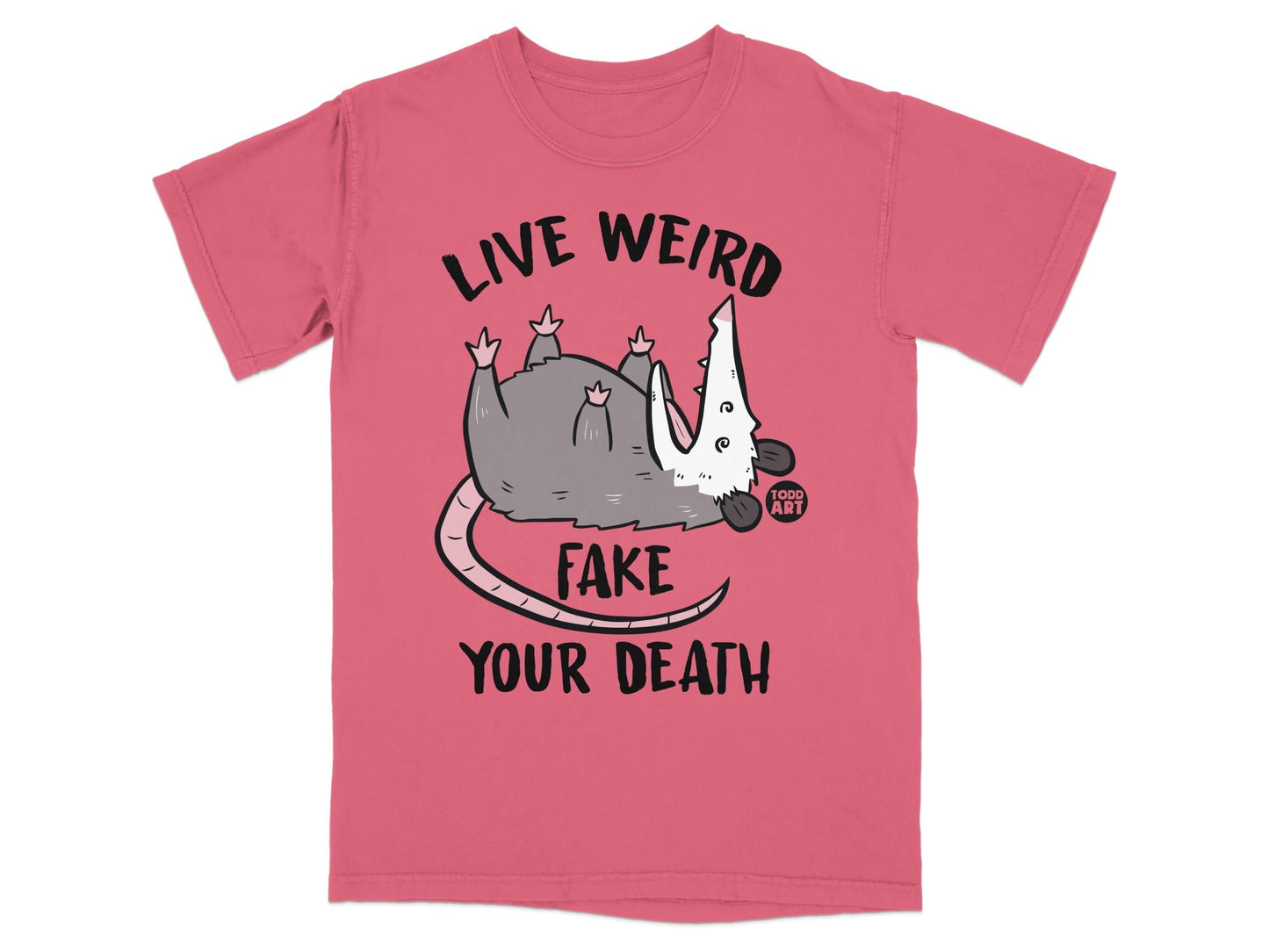 Pink t-shirt with a possum and text "LIVE WEIRD FAKE YOUR DEATH".