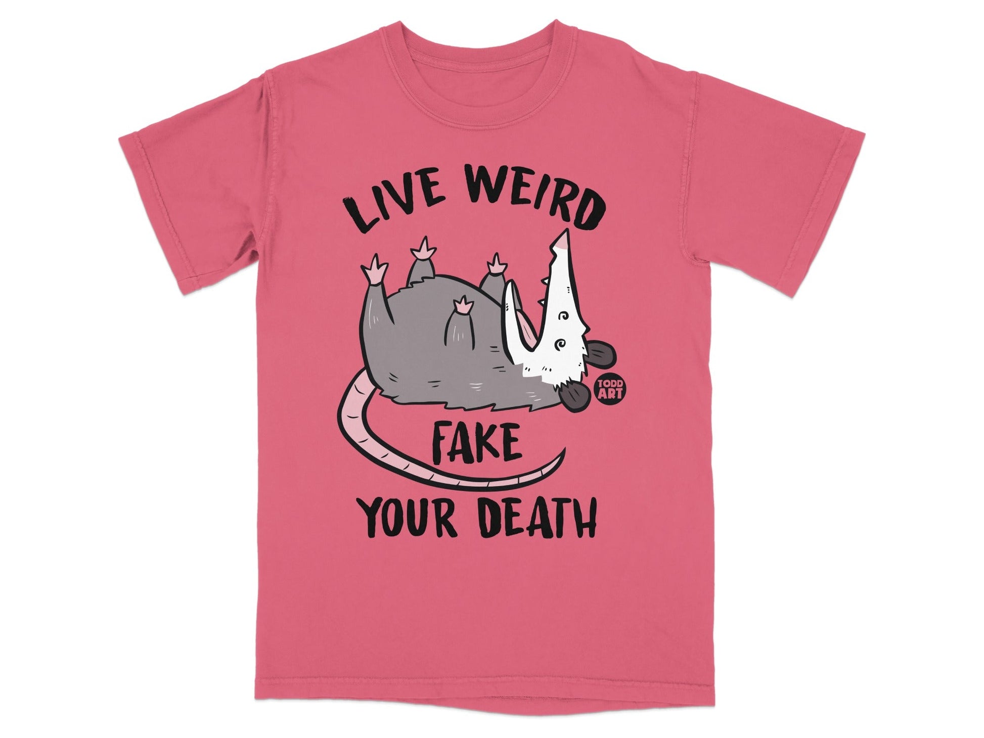 Pink t-shirt with a possum and text "LIVE WEIRD FAKE YOUR DEATH".