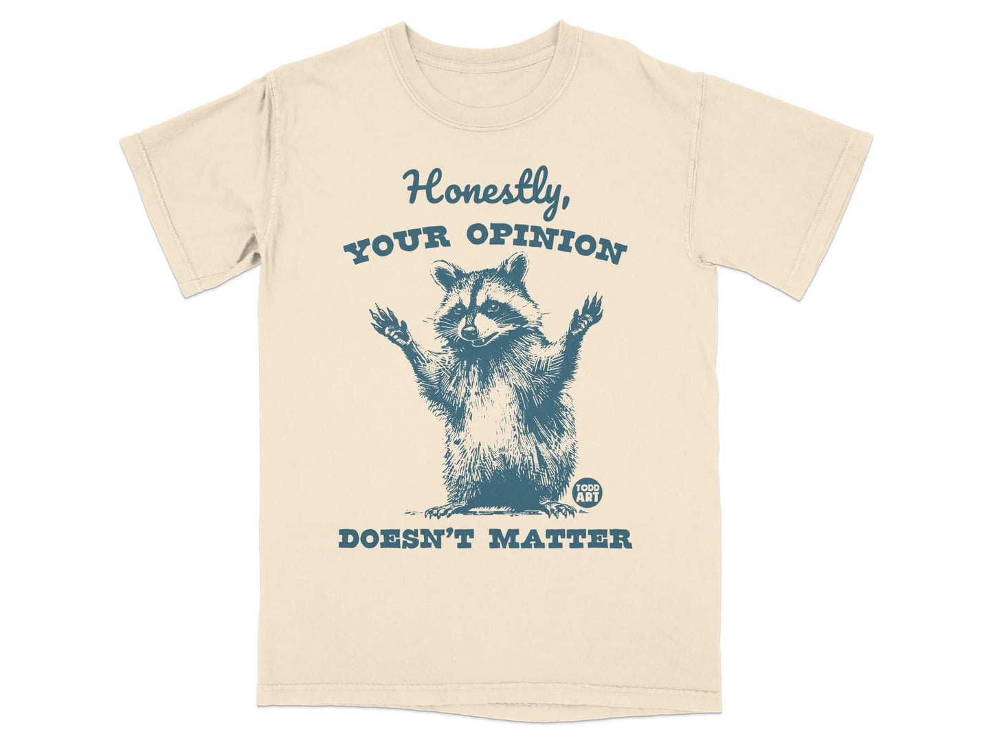 Cream t-shirt with raccoon graphic and text "Honestly, your opinion doesn't matter."