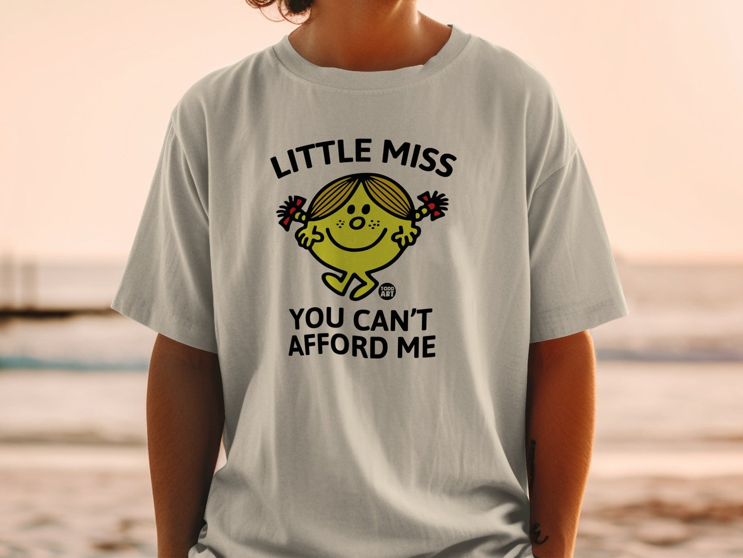 Little Miss character with text "YOU CAN'T AFFORD ME" on a t-shirt.