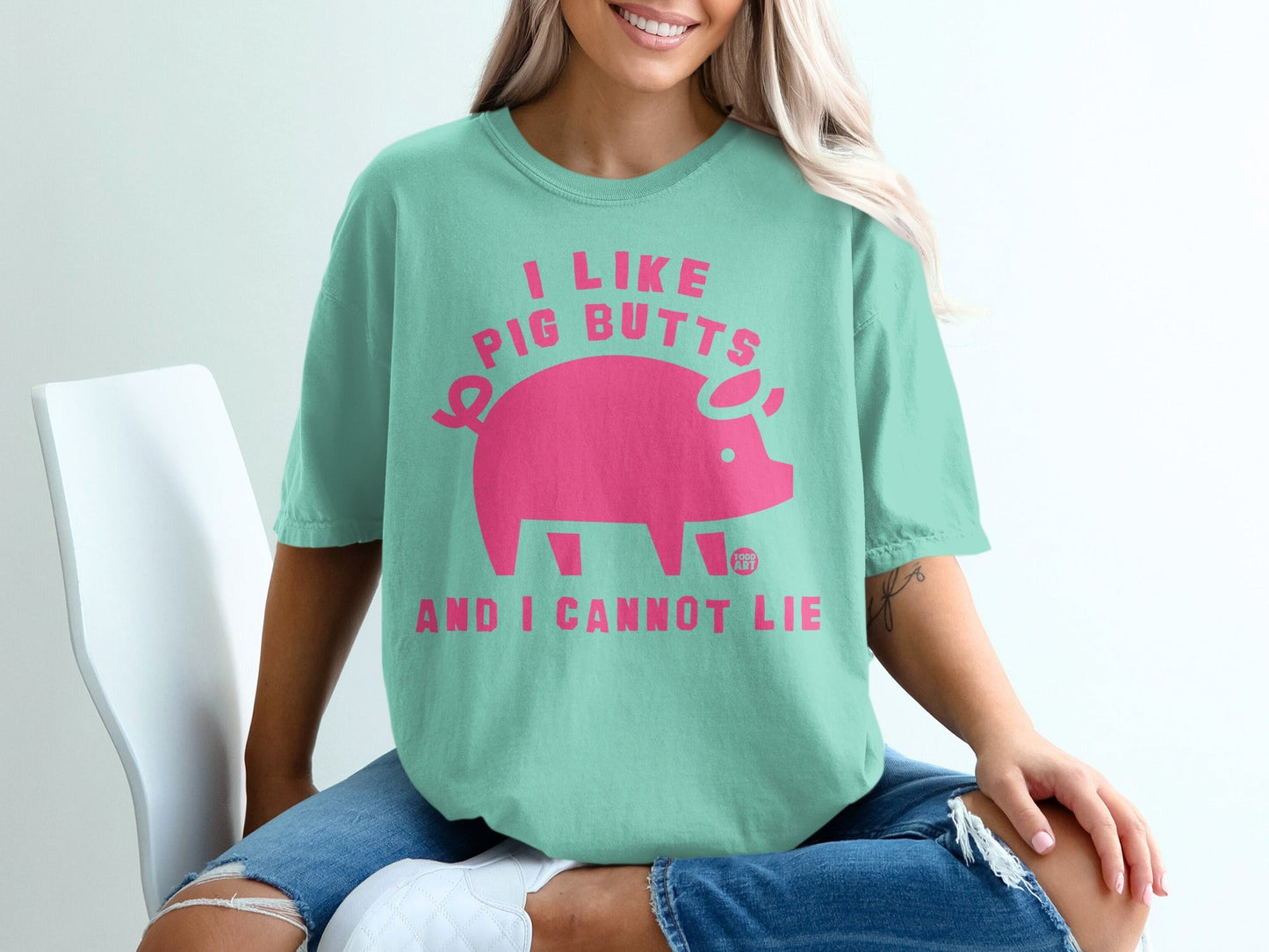Mint green t-shirt with pink pig graphic and text "I LIKE PIG BUTTS AND I CANNOT LIE".