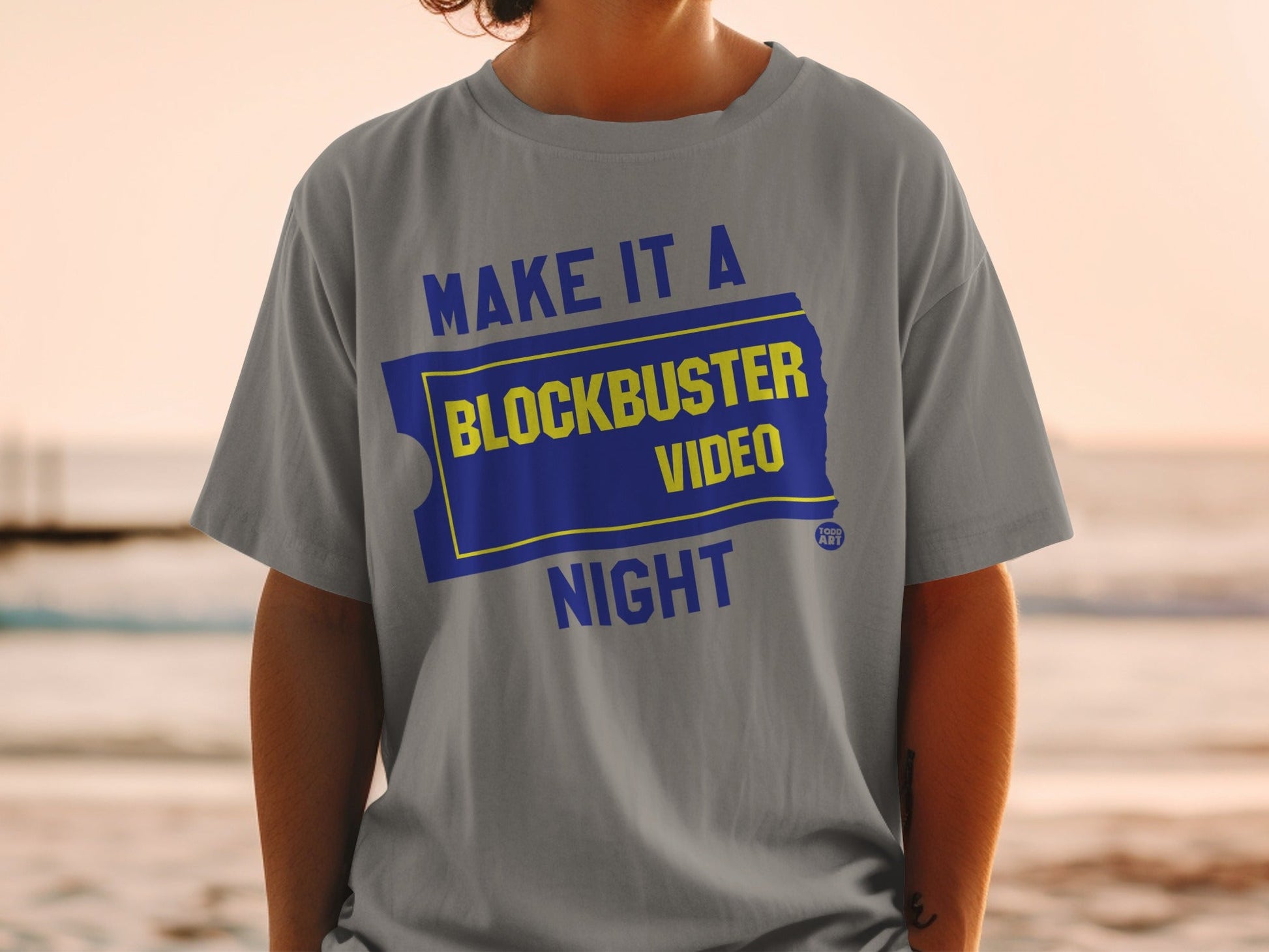 Gray t-shirt with "MAKE IT A BLOCKBUSTER NIGHT" text and Blockbuster logo.