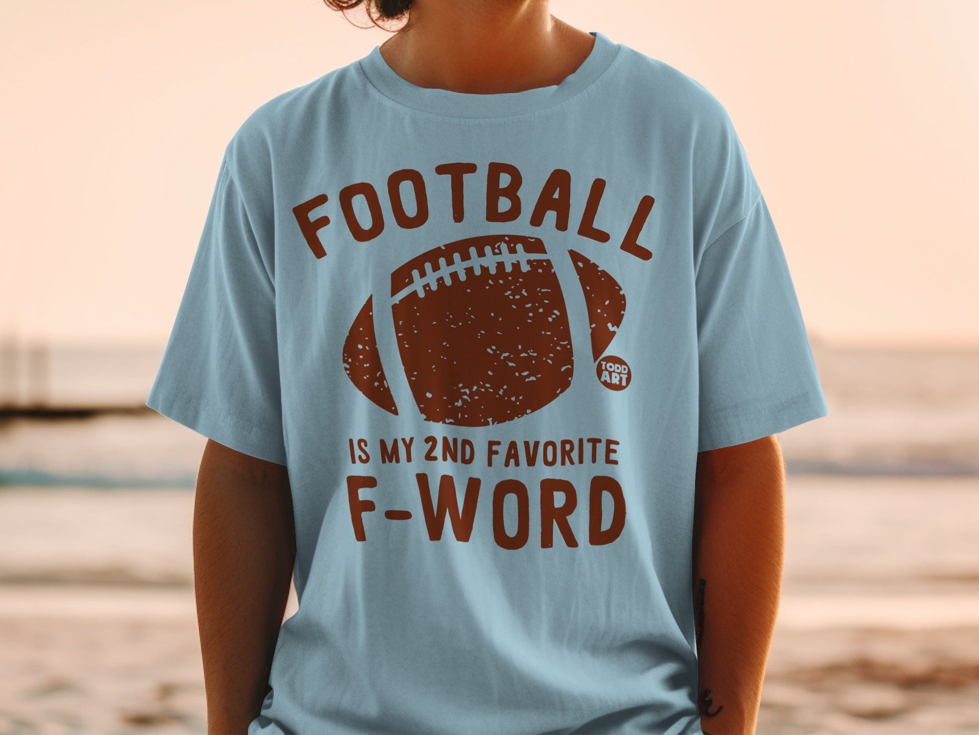 Light blue t-shirt with football graphic and "Football is my 2nd favorite F-word" text.