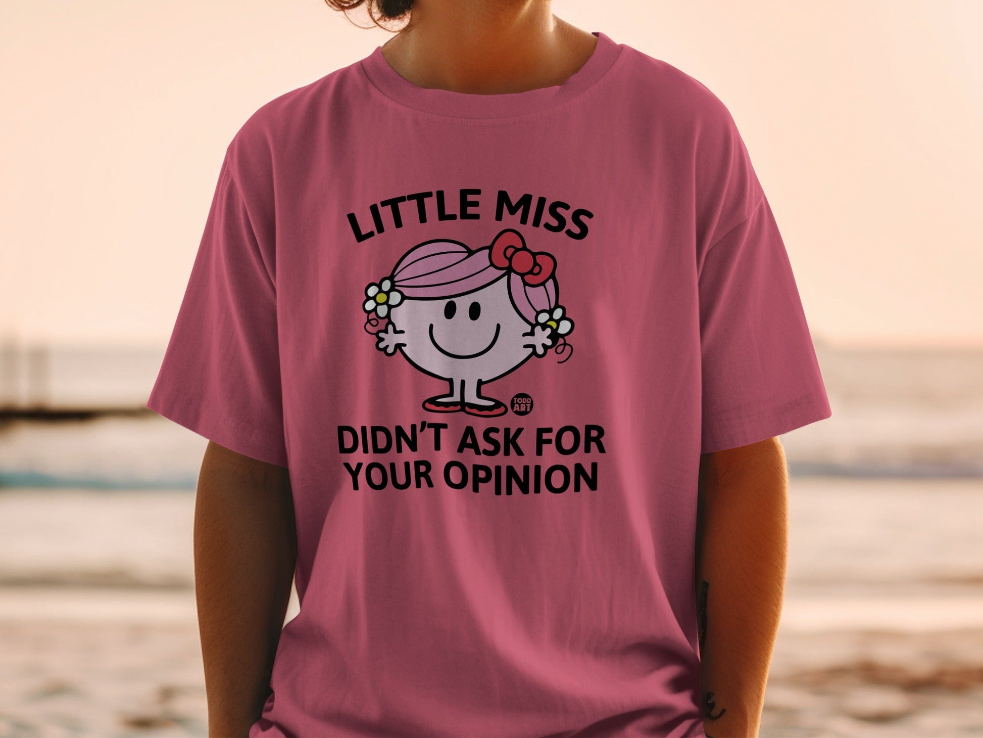 Pink t-shirt with "Little Miss Didn't Ask For Your Opinion" text and cartoon character.