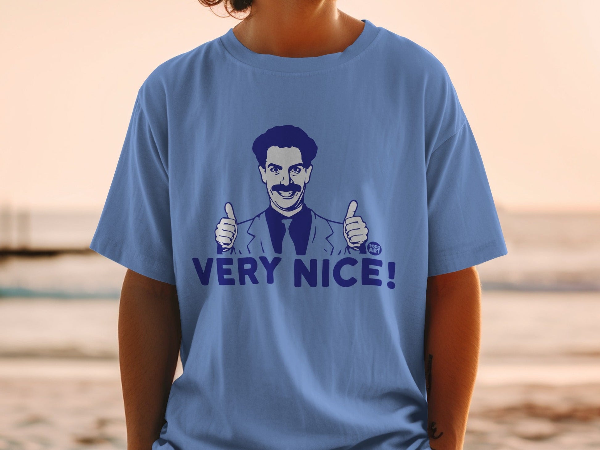 Blue t-shirt with Borat character giving two thumbs up, text "VERY NICE!".