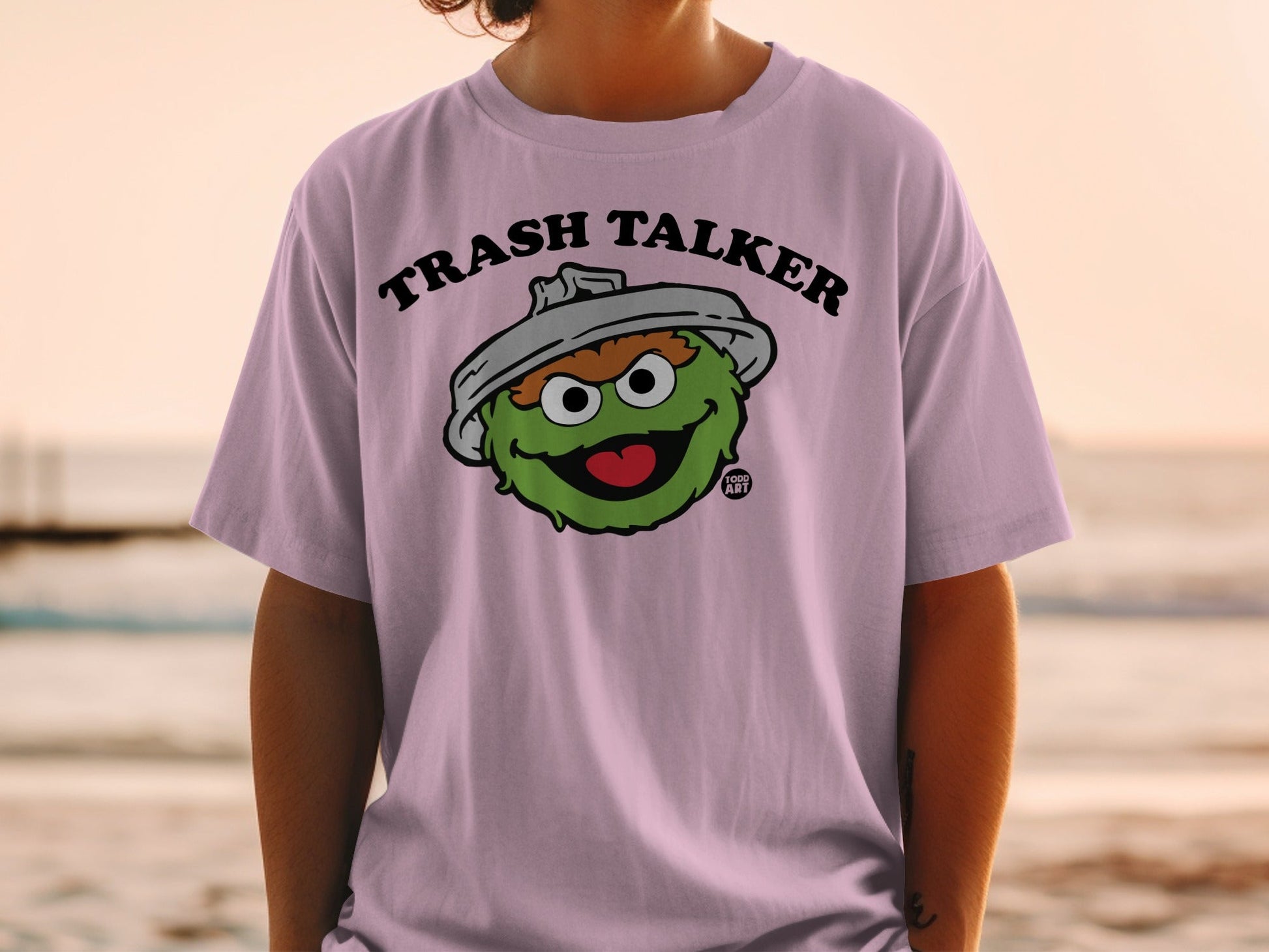 Pink t-shirt featuring Oscar the Grouch with "Trash Talker" text.