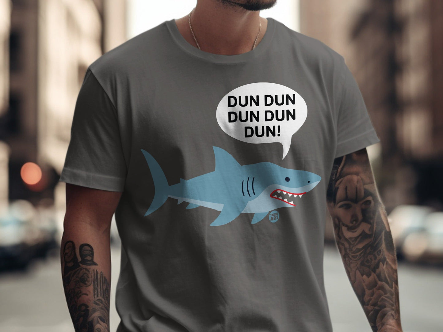 Grey t-shirt with a cartoon shark and "DUN DUN DUN DUN!" speech bubble.