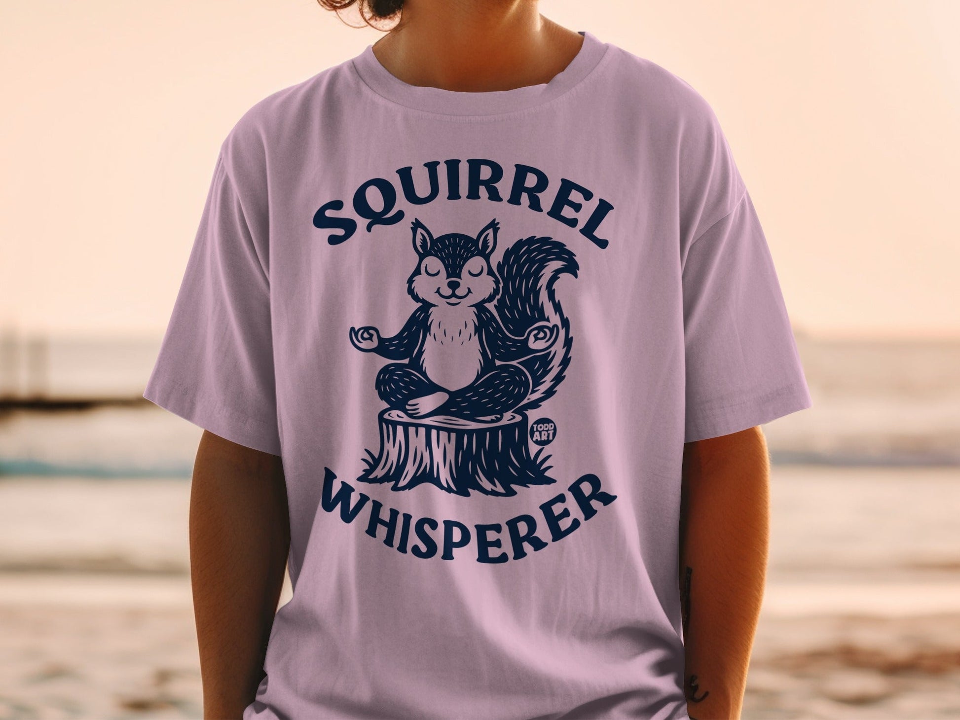 T-shirt with a meditating squirrel and the text "Squirrel Whisperer".