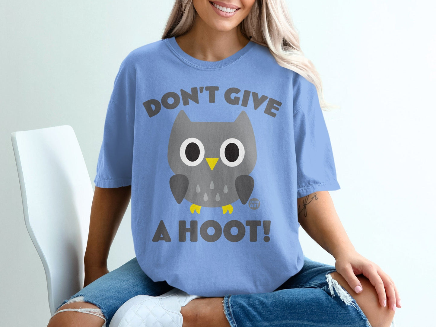 Light blue t-shirt with a cartoon owl and text "DON'T GIVE A HOOT!".