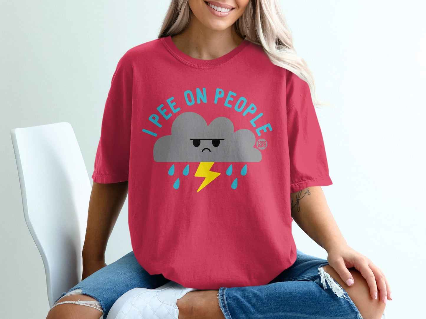 Red t-shirt with a cartoon cloud raining lightning bolts and text "I PEE ON PEOPLE".