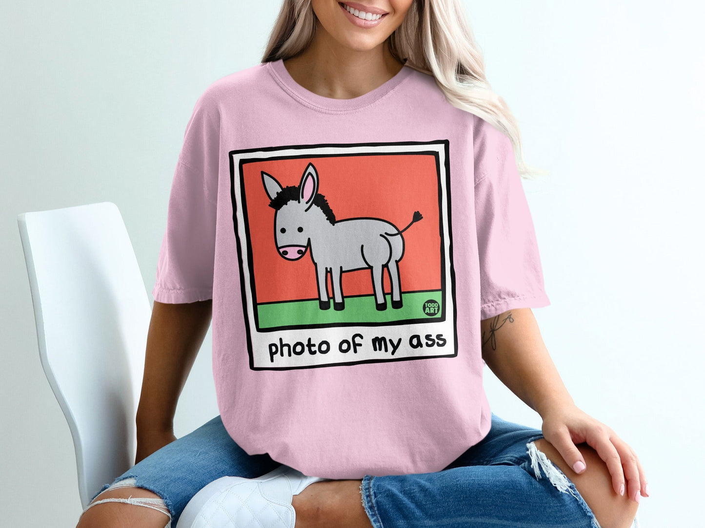 Pink t-shirt with a cartoon donkey and "photo of my ass" text.